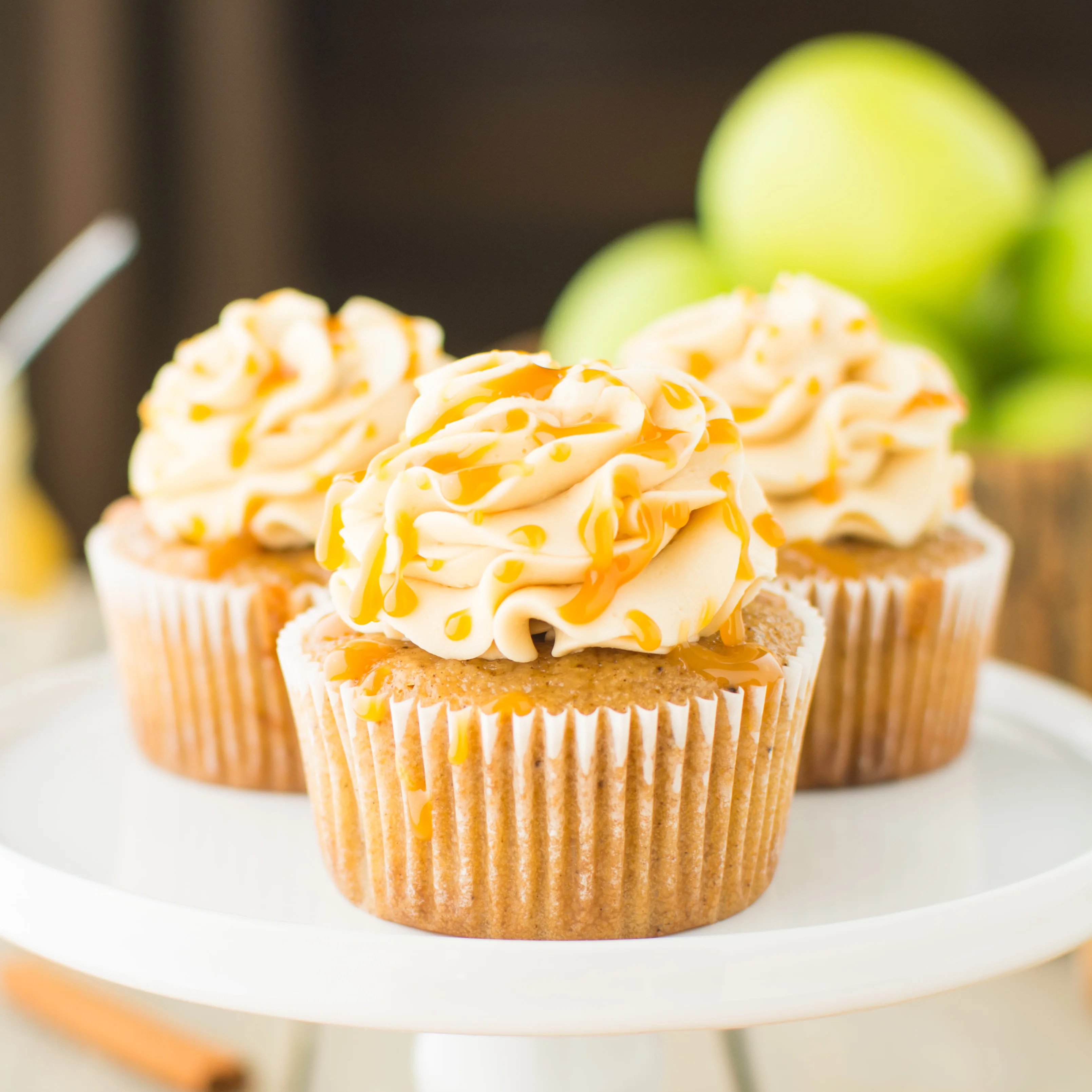 Fluffy apple-spiced cupcakes topped with a smooth and silky caramel swiss meringue buttercream!