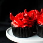 Super moist and intensely dark chocolate devil's food cupcakes with a kick of cinnamon, chili powder, and cayenne, topped with a red velvet buttercream and darling little devil horns!