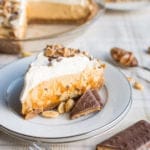 A crisp graham cracker toffee crust filled with rich caramel, bits of toffee, fluffy peanut butter cream filling, and topped with whipped cream and even more toffee bits!