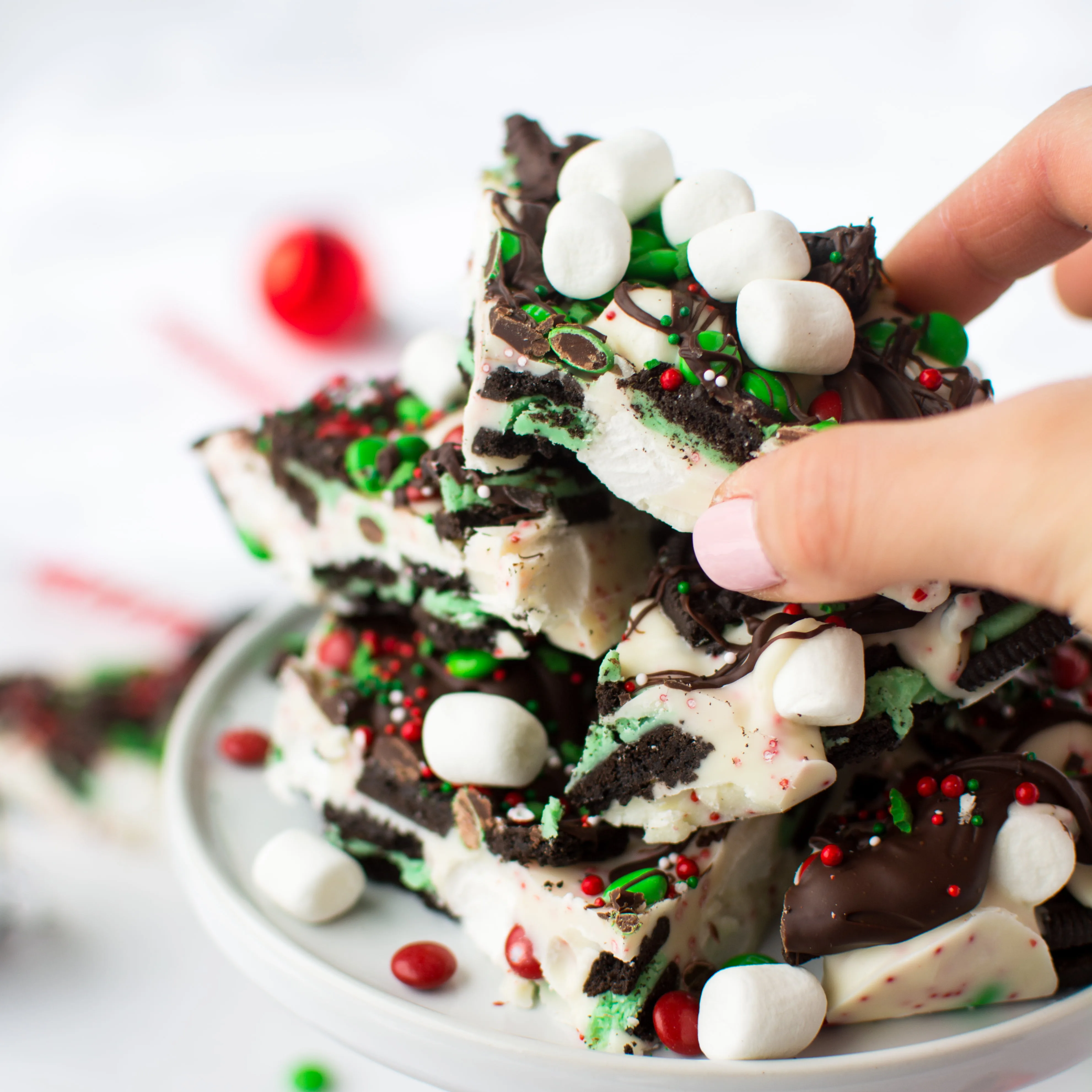 Minty Oreos, marshmallows, and M&Ms embedded in peppermint-speckled white chocolate and drizzled with dark chocolate! Don't forget the sprinkles!