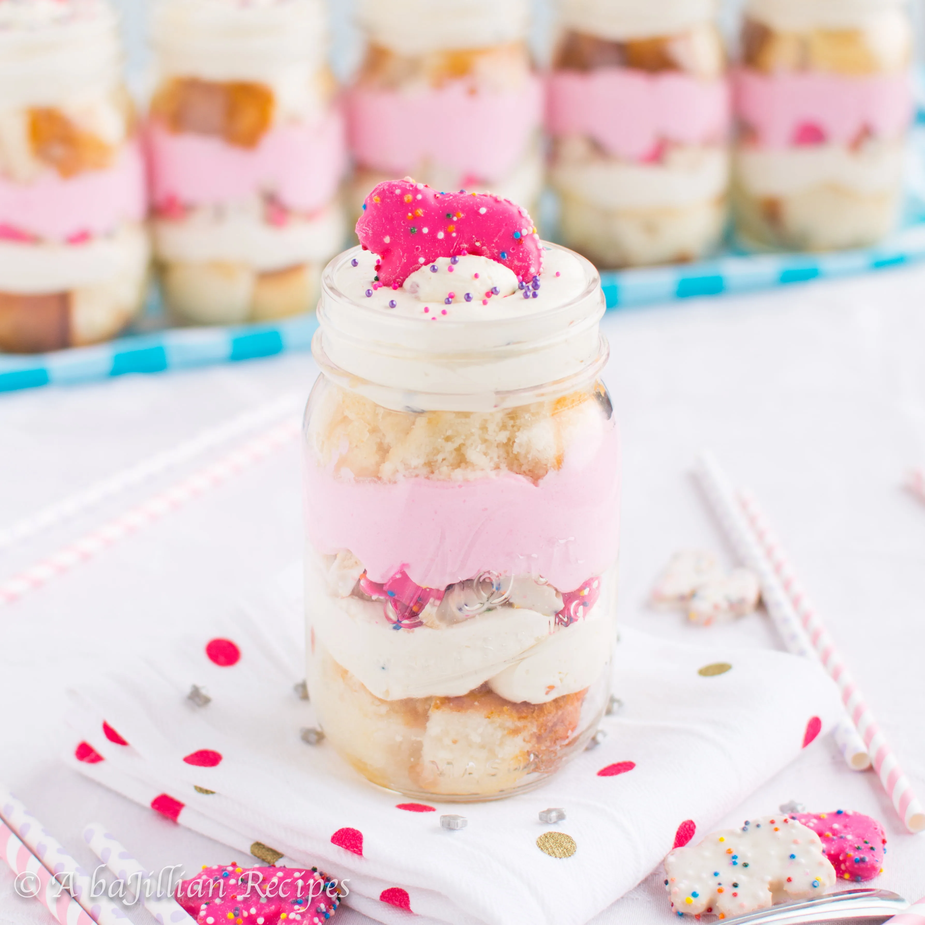 Individual trifles layered with cubes of light and fluffy white cake, white chocolate pudding, rainbow chip cheesecake mousse, and frosted Circus Animal cookies!