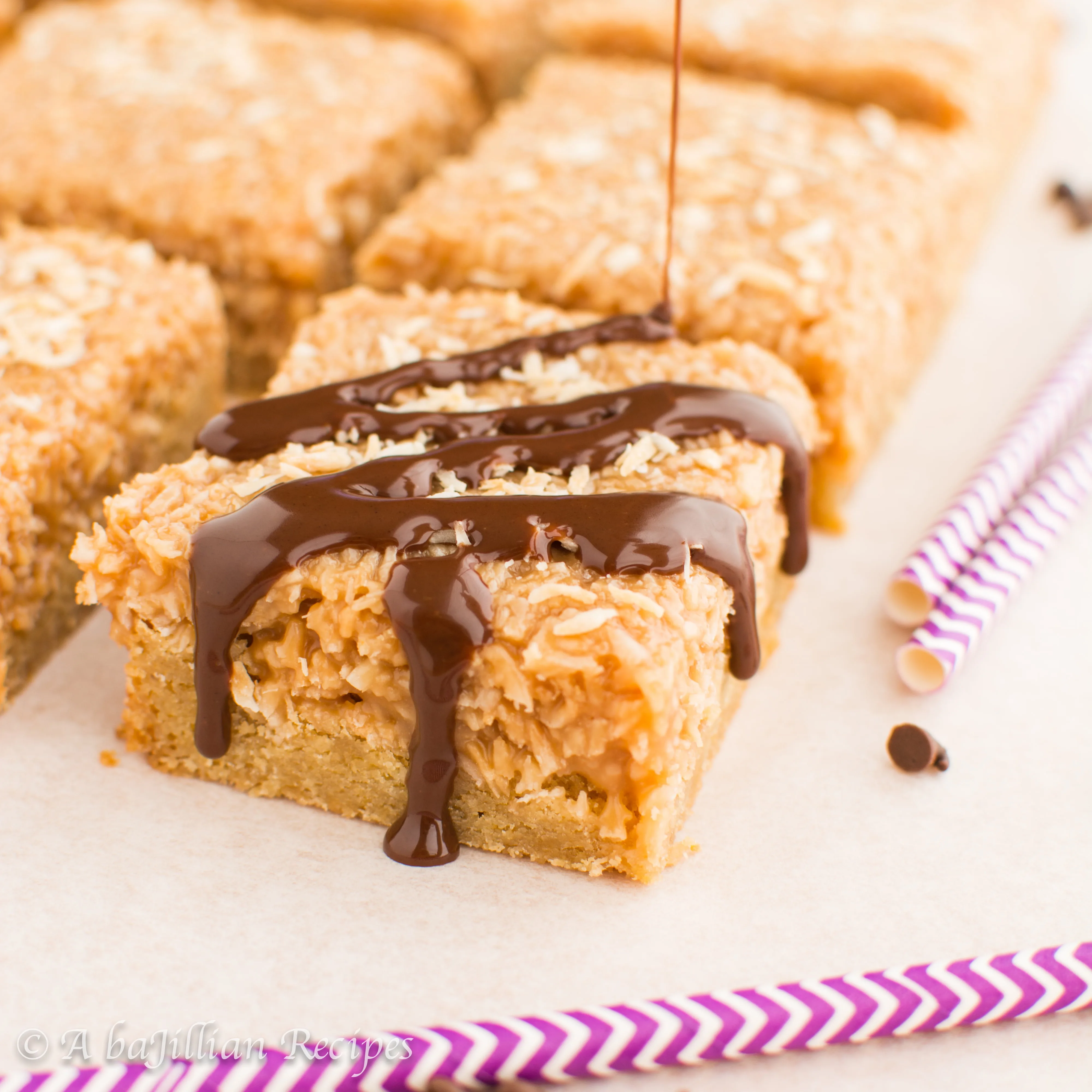 Brown buttery blondies with a caramely coconut layer and drizzled in chocolate ganache!