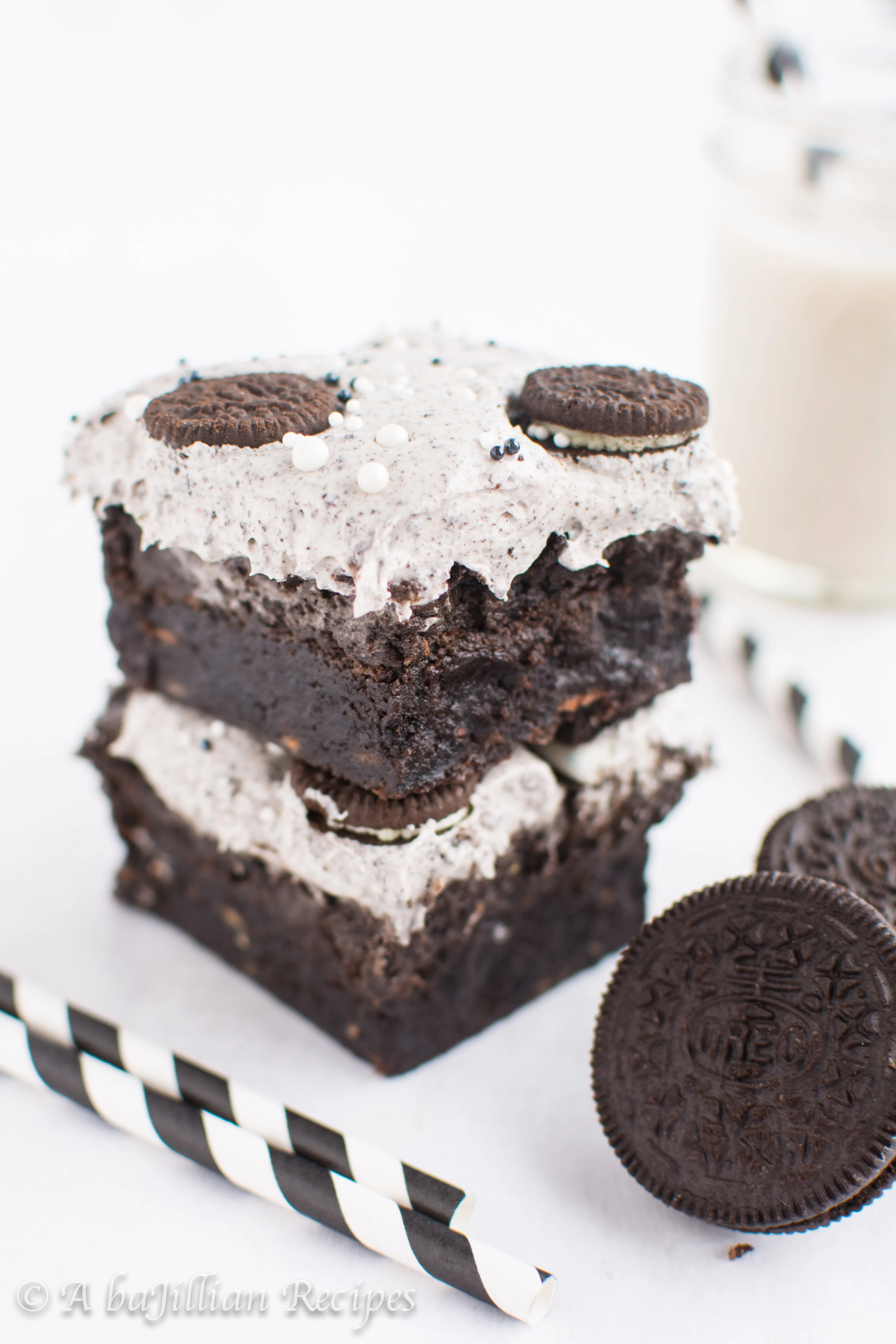 Thick and fudgy brownies, Oreo truffle filling, and fluffy Oreo frosting! THREE layers of Oreo deliciousness in one bite!