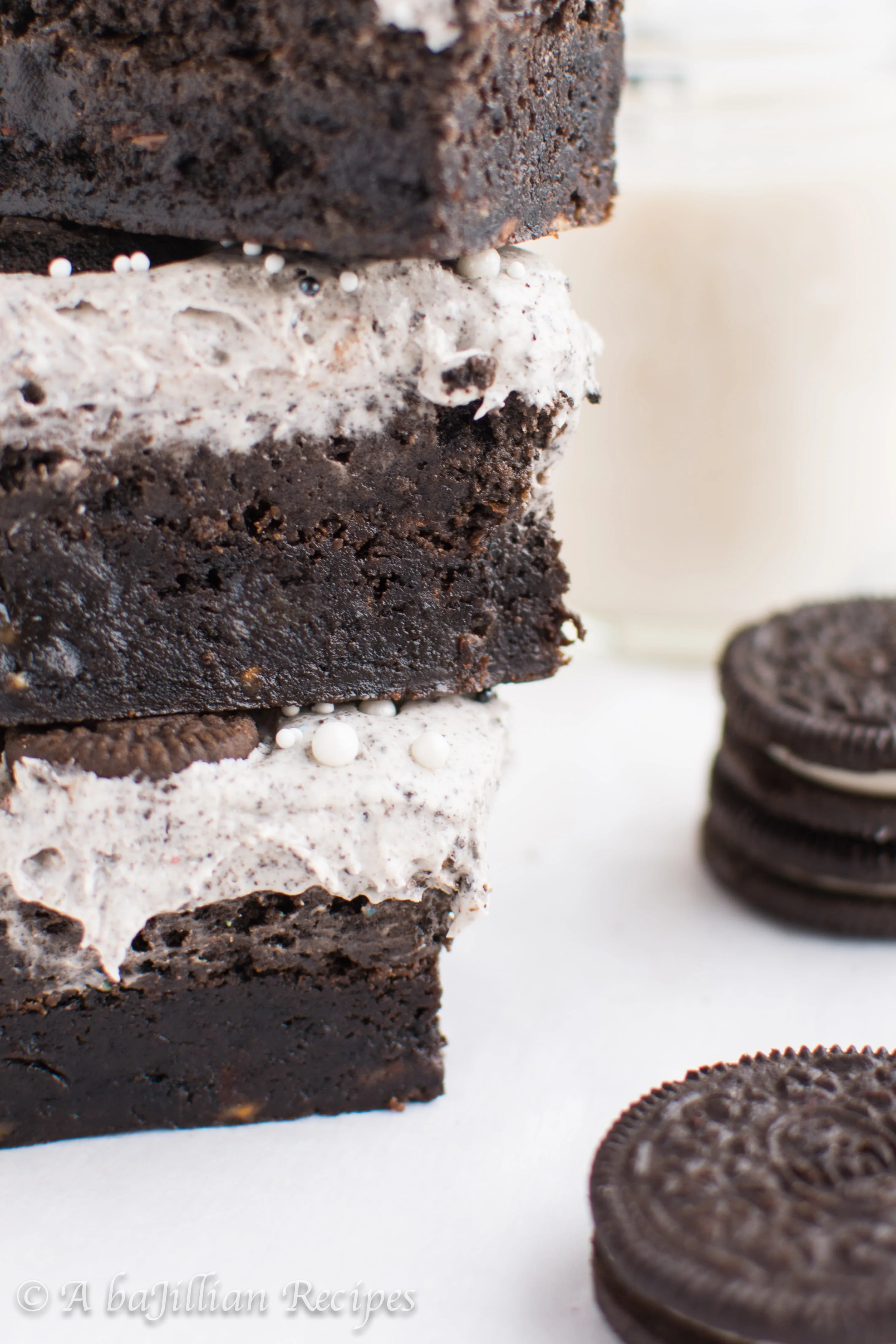 Thick and fudgy brownies, Oreo truffle filling, and fluffy Oreo frosting! THREE layers of Oreo deliciousness in one bite!