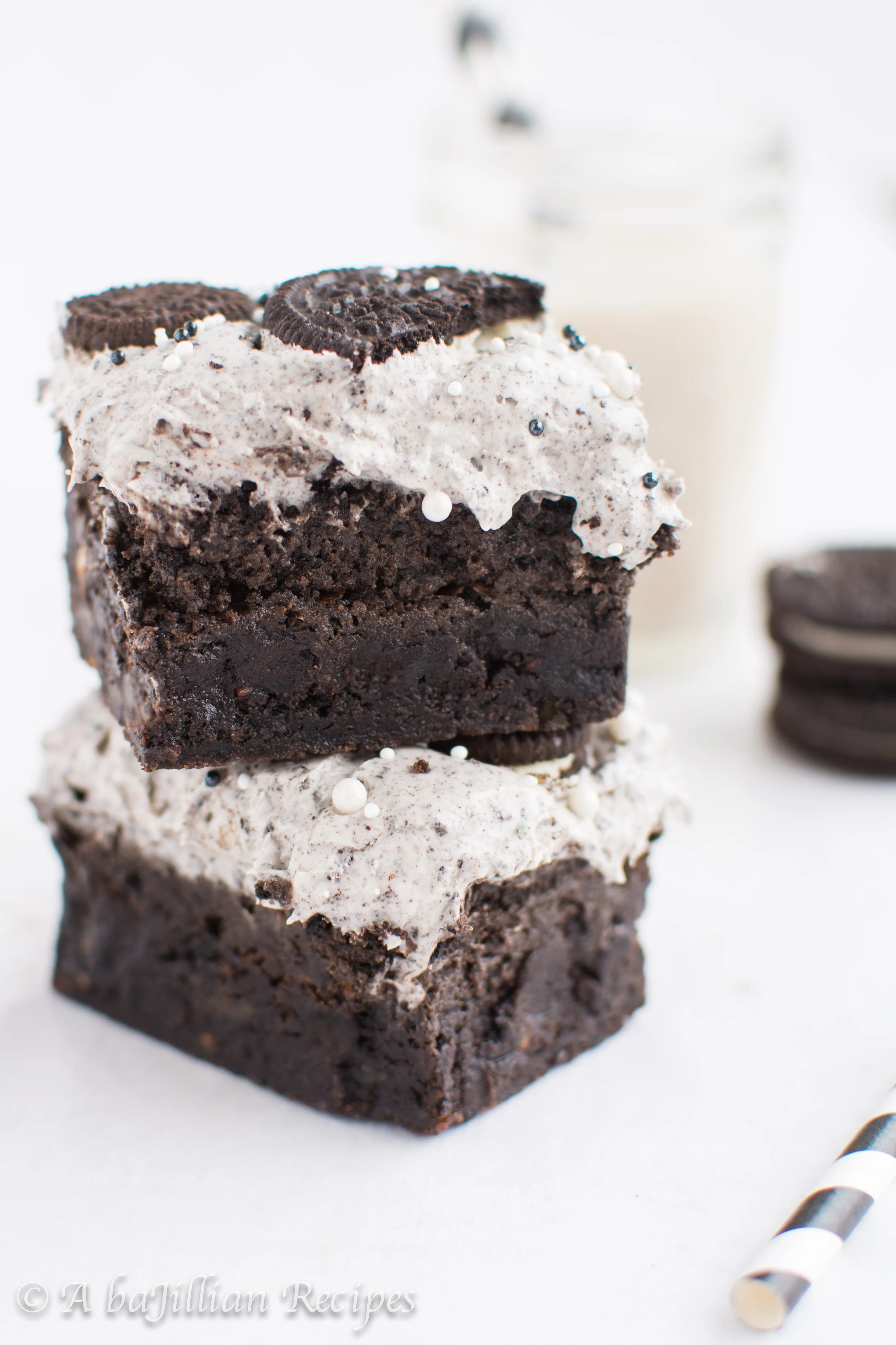 Thick and fudgy brownies, Oreo truffle filling, and fluffy Oreo frosting! THREE layers of Oreo deliciousness in one bite!