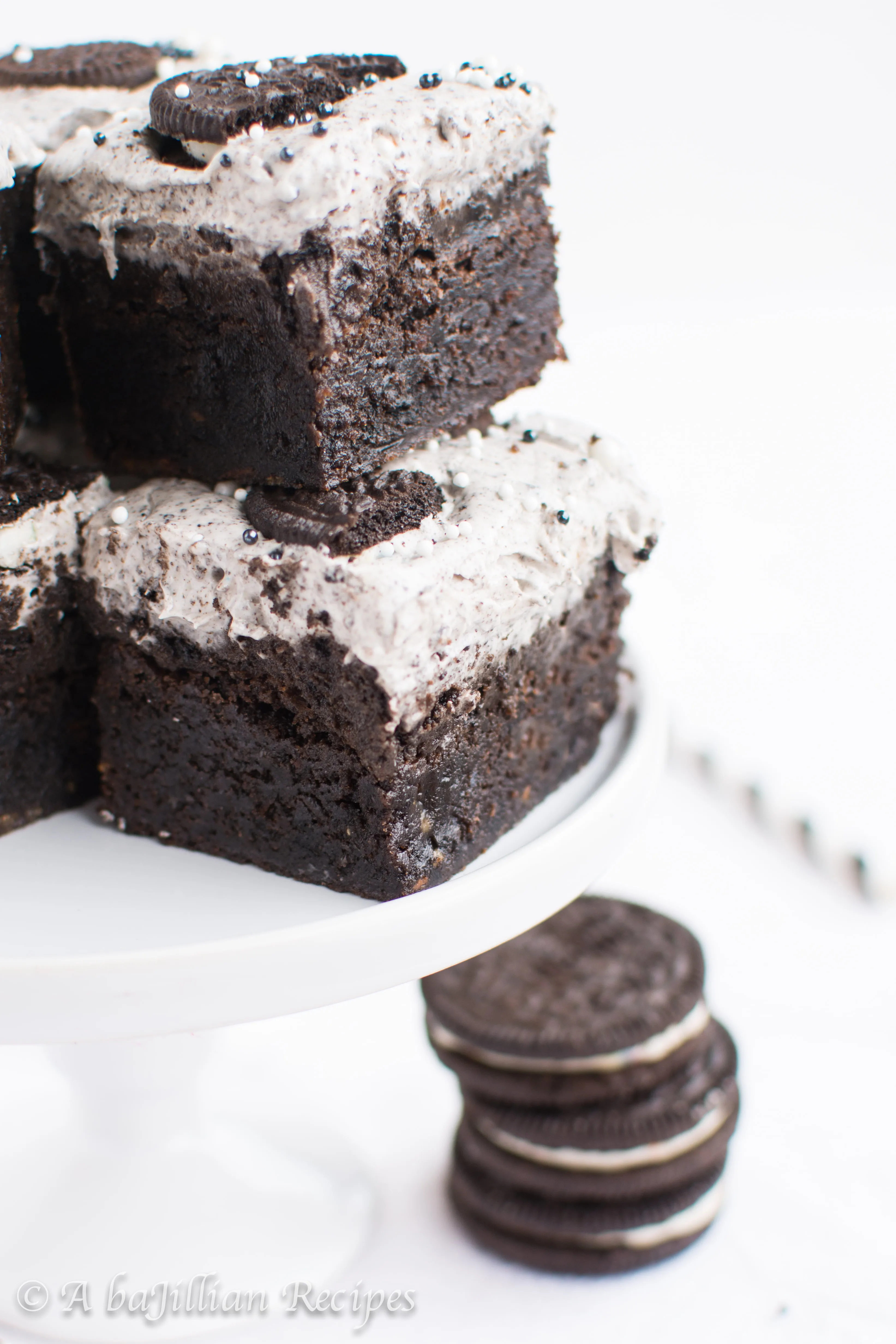 Thick and fudgy brownies, Oreo truffle filling, and fluffy Oreo frosting! THREE layers of Oreo deliciousness in one bite!