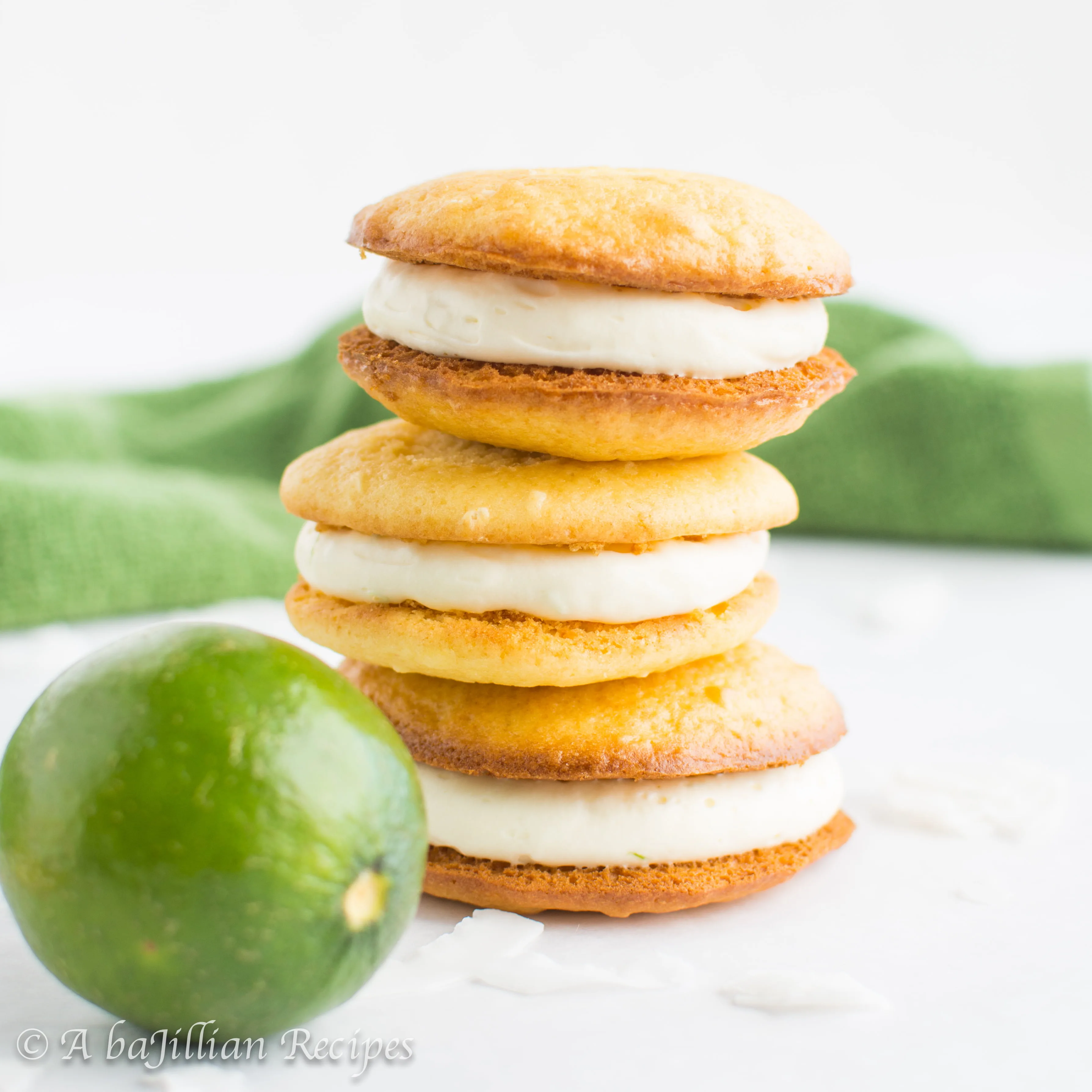 Tart and tangy lime cheesecake filling sandwiched between two light and fluffy coconut cake cookies!