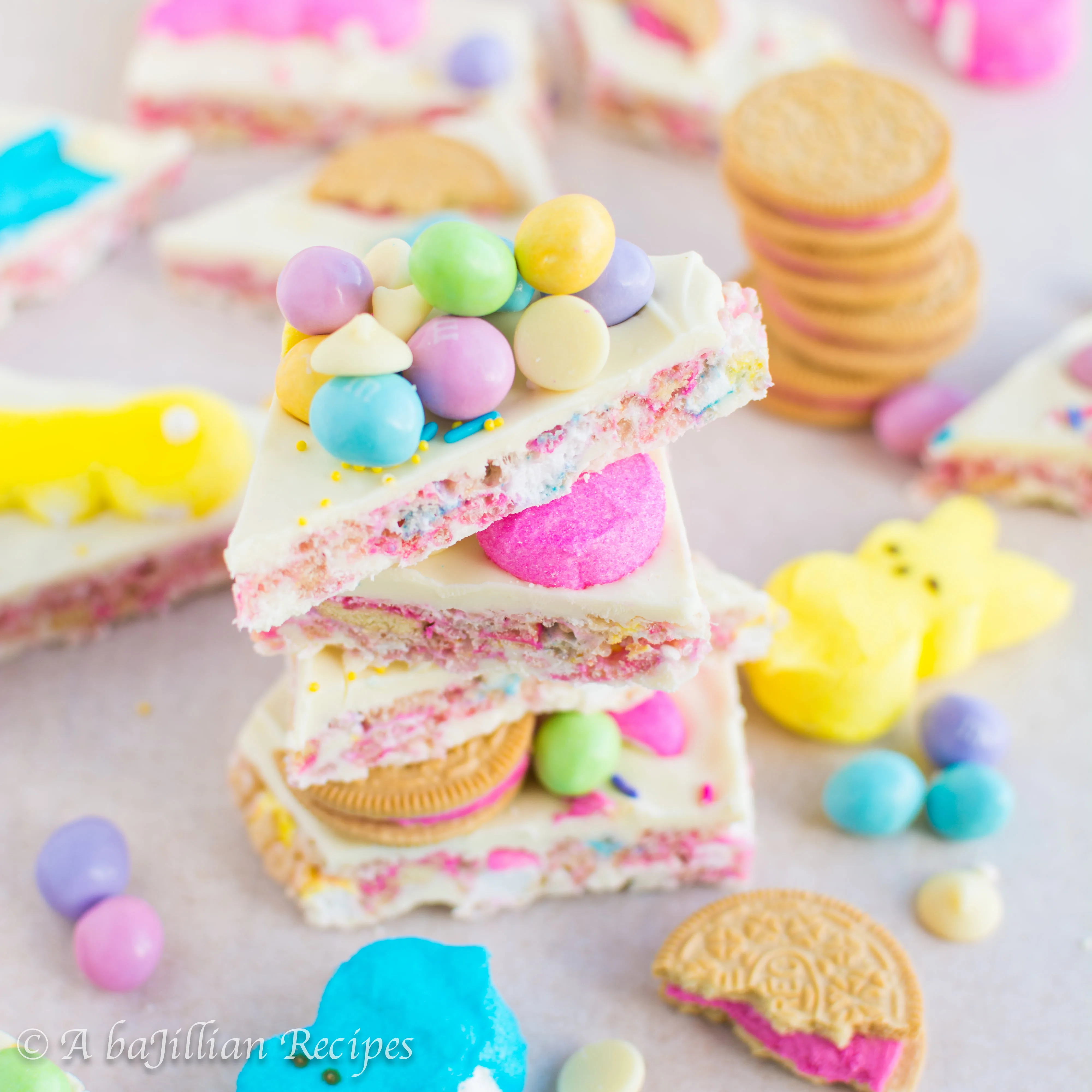 Marshmallowy Peeps rice krispies sandwiched between rich white chocolate and adorned with M&Ms, sprinkles, and Peeps Oreos!
