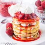 Soft and fluffy ricotta pancakes layered with a rich and creamy cheesecake filling and drowned in a lusciously sweet strawberry topping!
