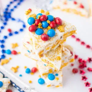 This white chocolatey Wonder Woman Caramel Crunch Bark is filled with marshmallowy Cap'n Crunch krispies and golden pockets of ooey gooey caramel!