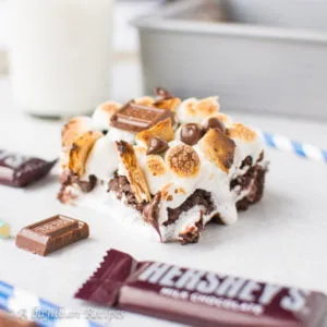 Chewy dark chocolatey brownies stuffed with ooey gooey marshmallow fluff and melty milk chocolate, topped with golden-roasted marshmallows, toasted graham crackers, and extra milk chocolate!