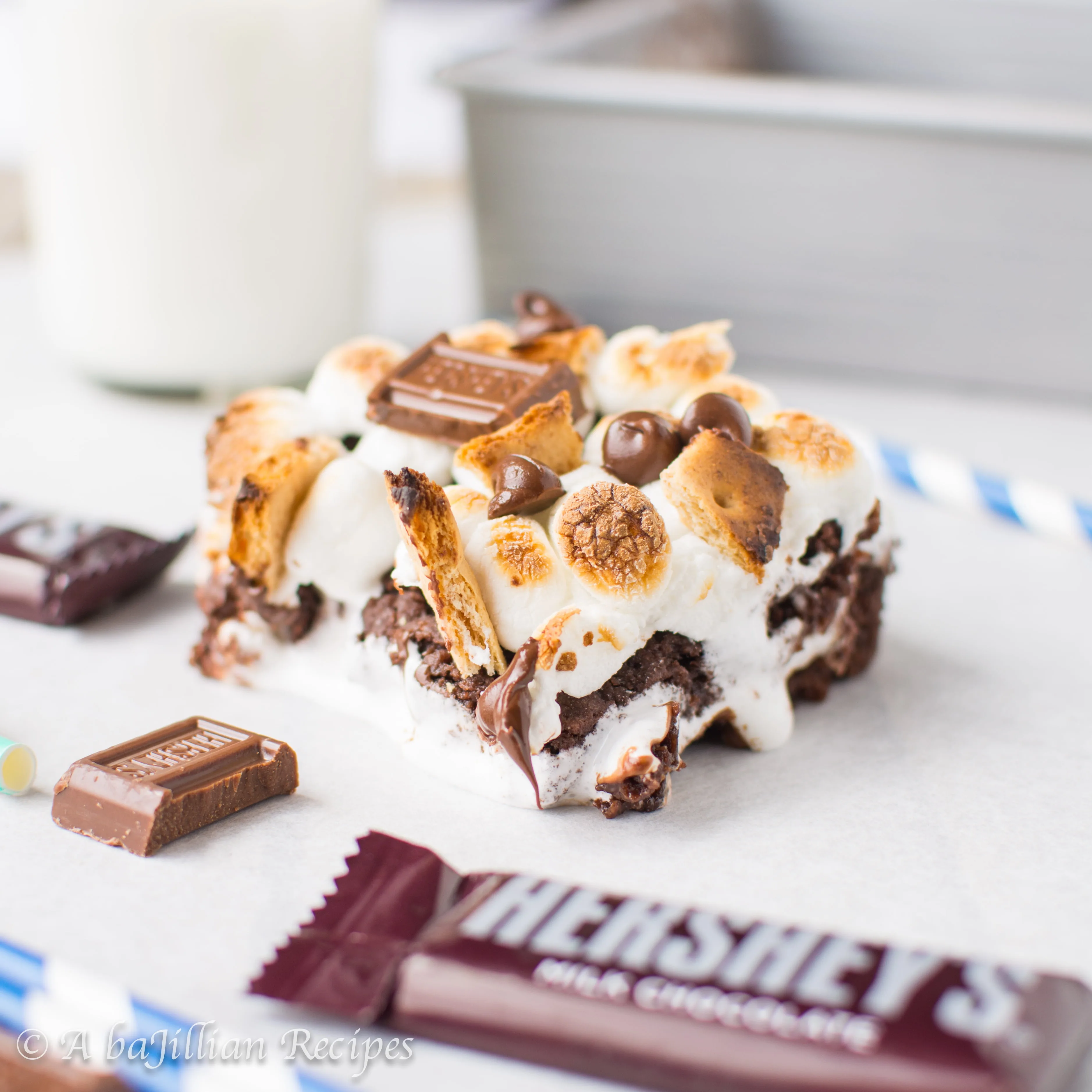 Chewy dark chocolatey brownies stuffed with ooey gooey marshmallow fluff and melty milk chocolate, topped with golden-roasted marshmallows, toasted graham crackers, and extra milk chocolate!