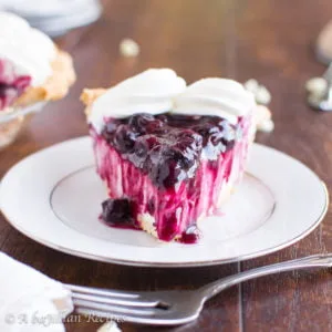 Smooth and creamy white chocolate cream filling in a golden, flakey crust and topped with the tastiest homemade blueberry sauce!