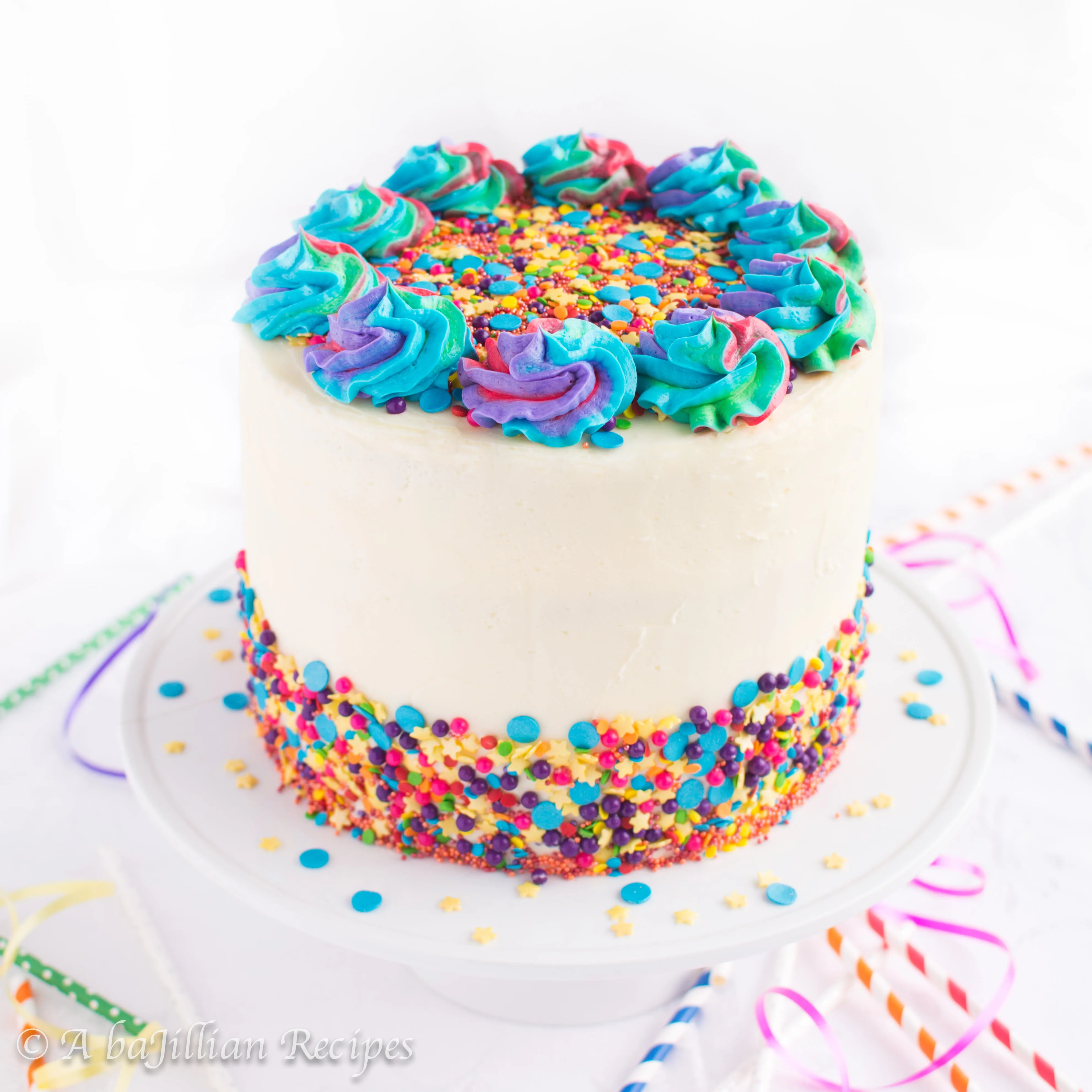 Soft and tender vanilla cake brimming with rainbow sprinkles, filled with rainbow chip cheesecake mousse and frosted in creamy vanilla buttercream! A childhood favorite made from scratch!