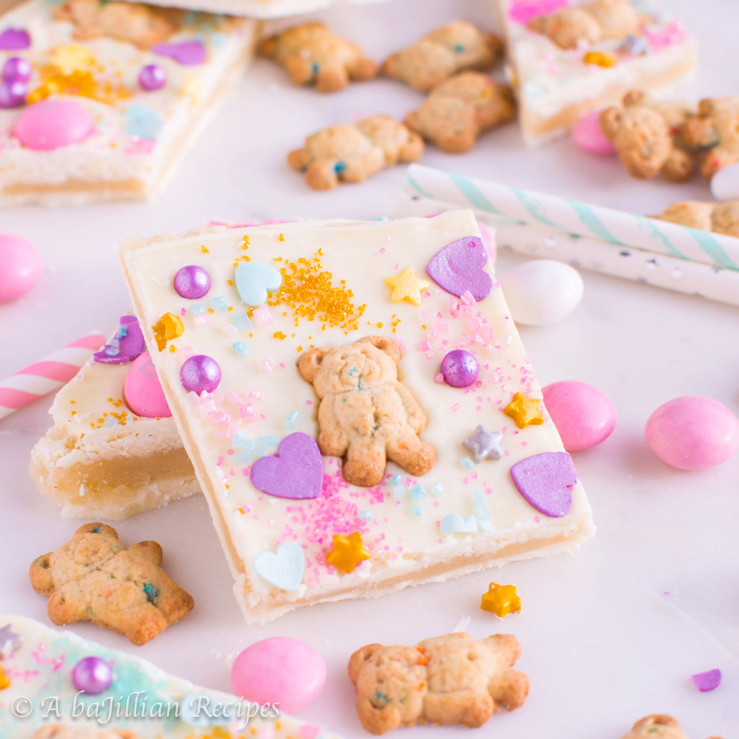 Sweet sugar cookie dough sandwiched between layers of rich white chocolate and "prettified" with sprinkles, Teddy Grahams, and M&Ms!