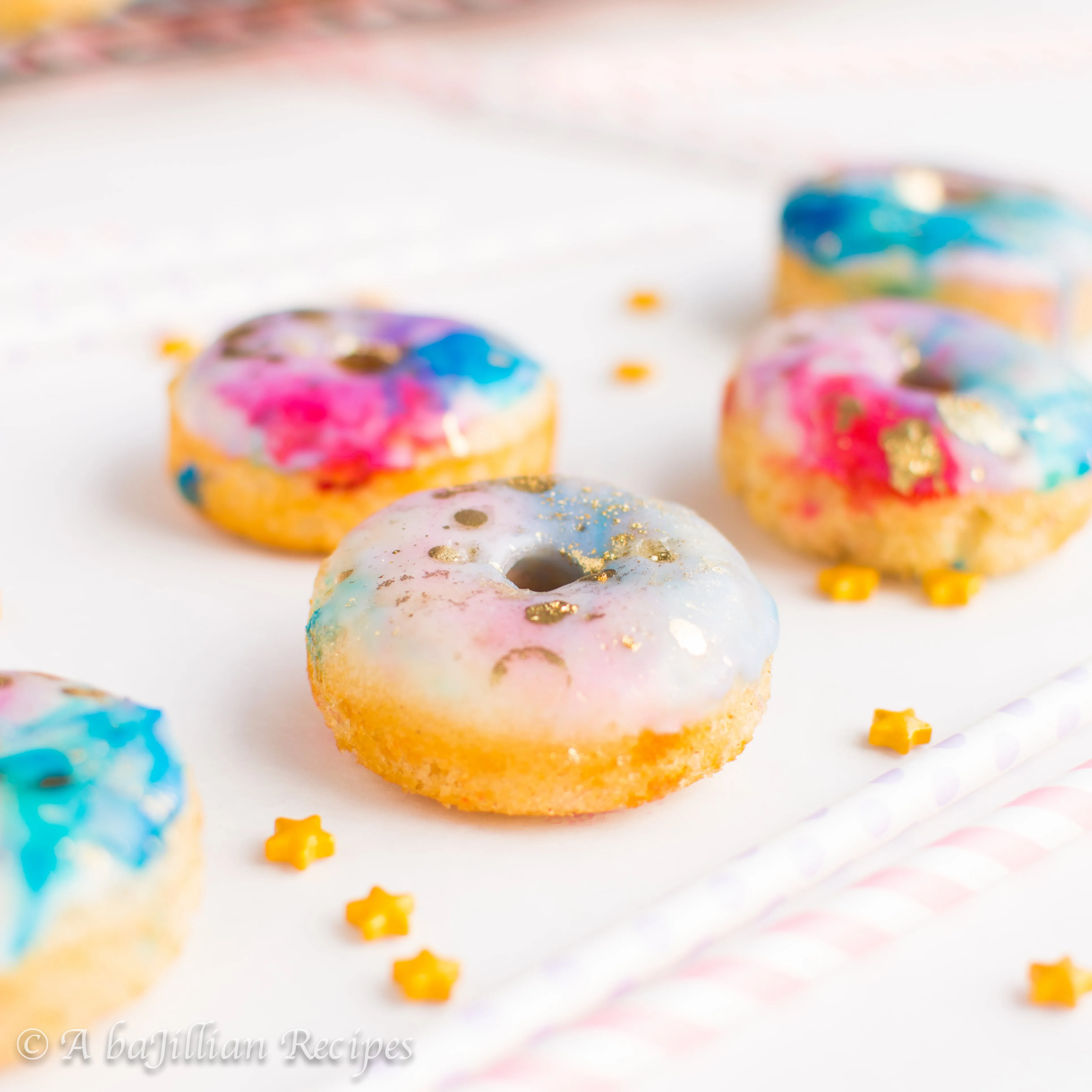 Delicate and fluffy mini funfetti donuts dipped in a beautiful marbleized glaze!