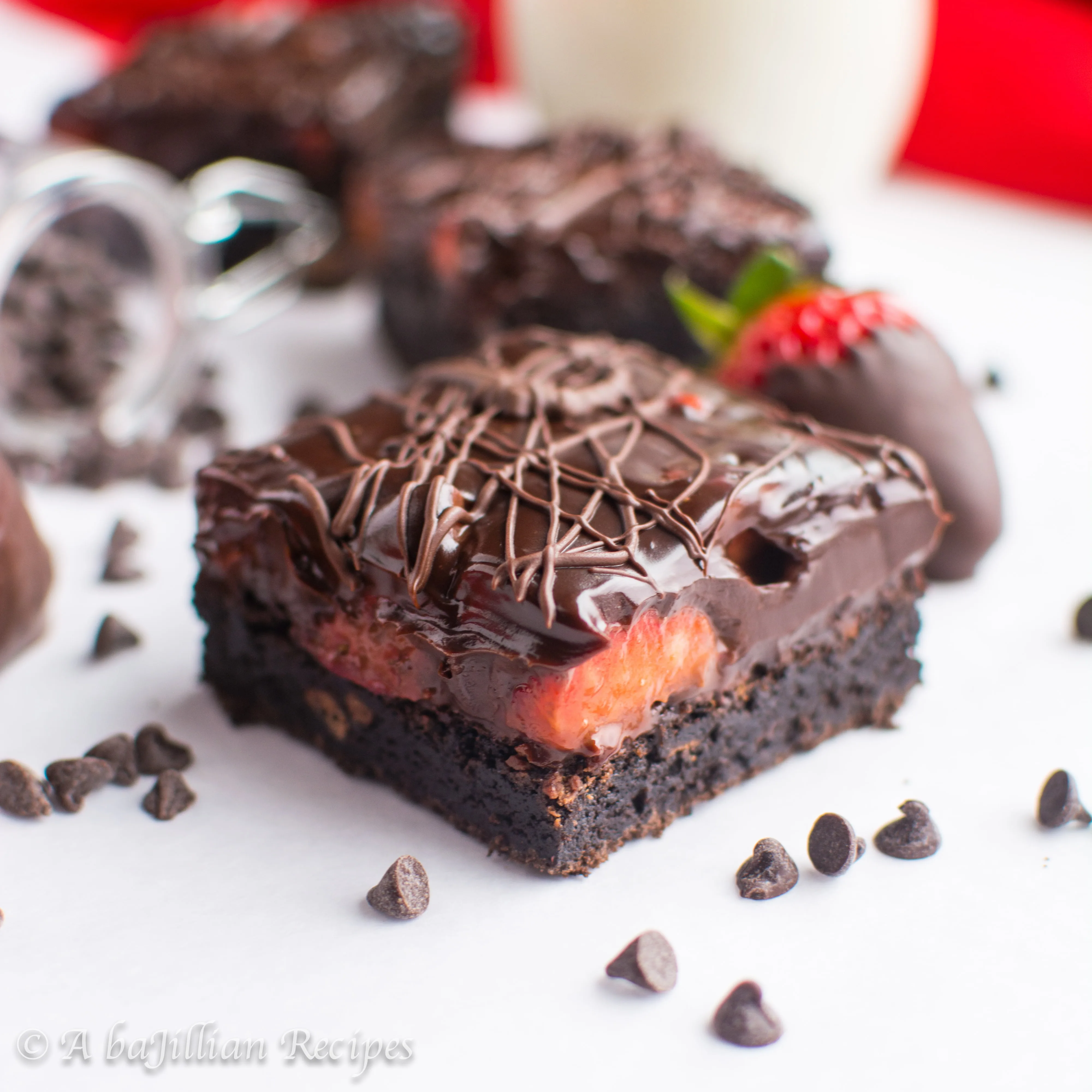 Ultra dense and fudgy brownies topped with fresh strawberries and smothered in rich dark chocolatey ganache!
