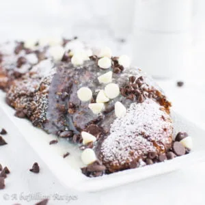 Buttery croissants soaked in a hot chocolate batter, coated in crushed cocoa puffs, fried until toasty, then topped with a finale of white chocolate ganache!