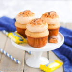 Fluffy peanut buttery cupcakes topped with a rich and creamy cloud of Butterfinger frosting!