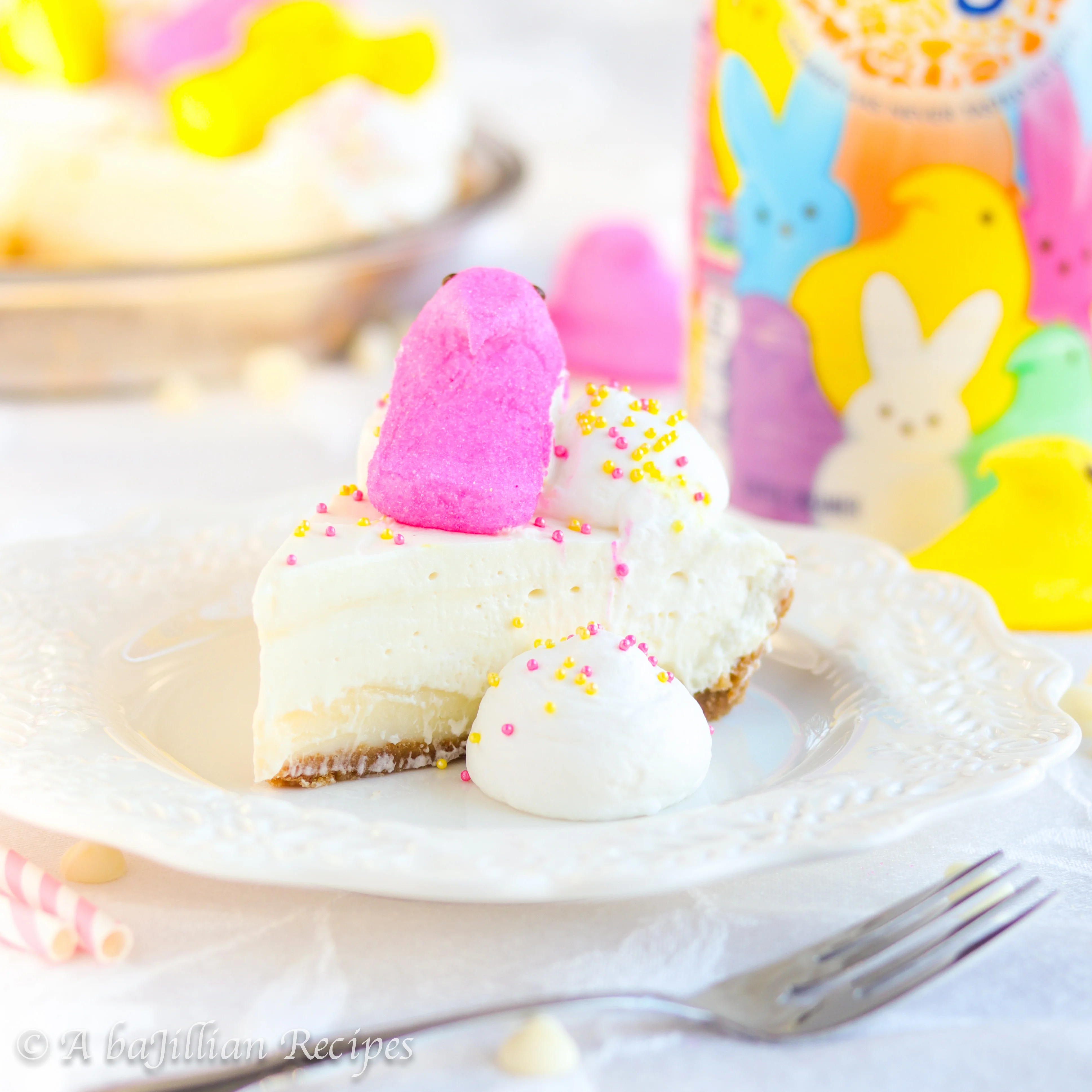 An easy graham cracker crust with a rich layer of white chocolate ganache, a fluffy layer of cotton candy-like filling, and decorated in the always adorable marshmallow Peeps!