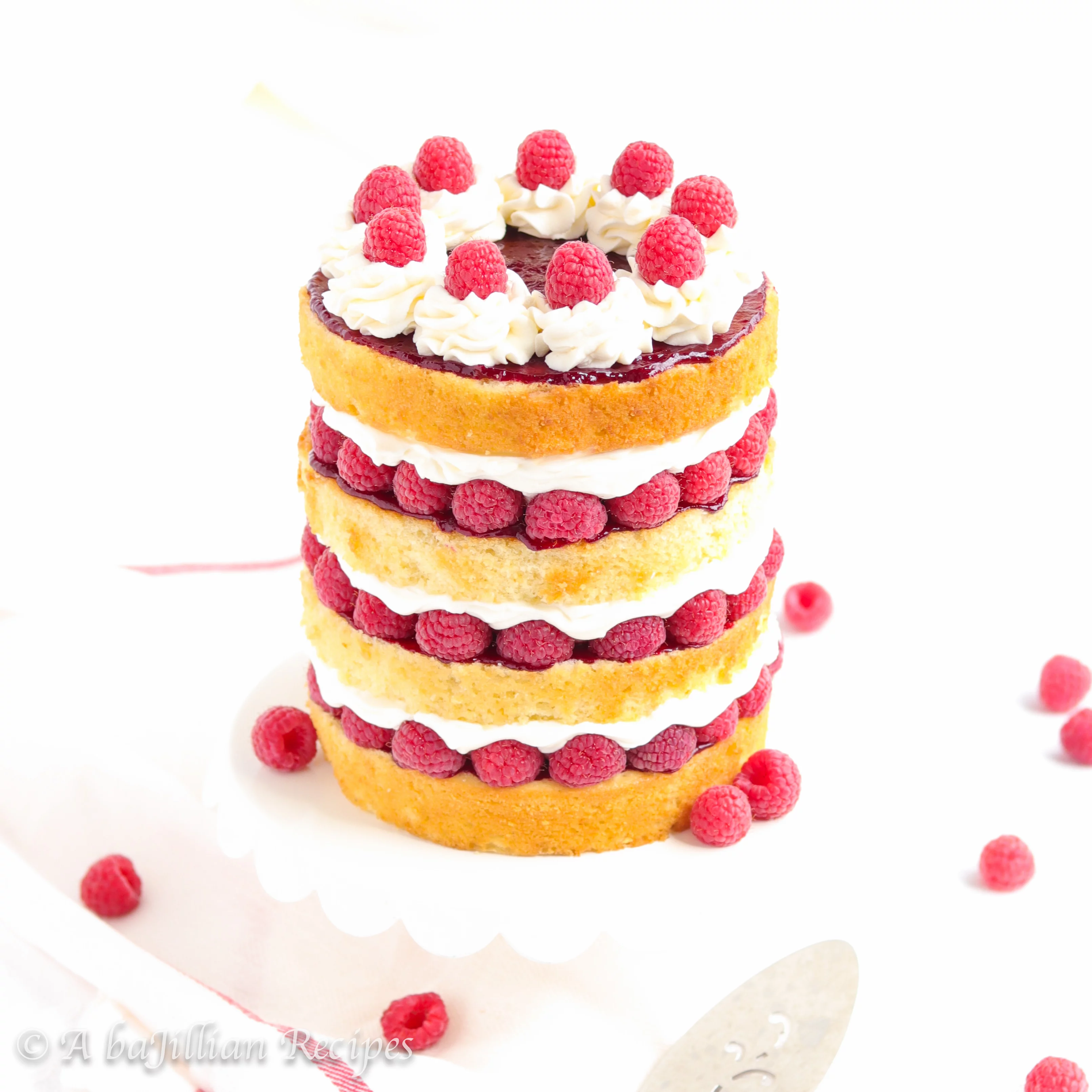Golden layers of moist vanilla cake layered between fluffy cream filling, raspberry compote, and fresh raspberries!
