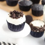 Chocolate Oreo cupcakes baked with a surprise Oreo in the bottom, topped with a creamy vanilla buttercream, and crowned with more crushed Oreos!