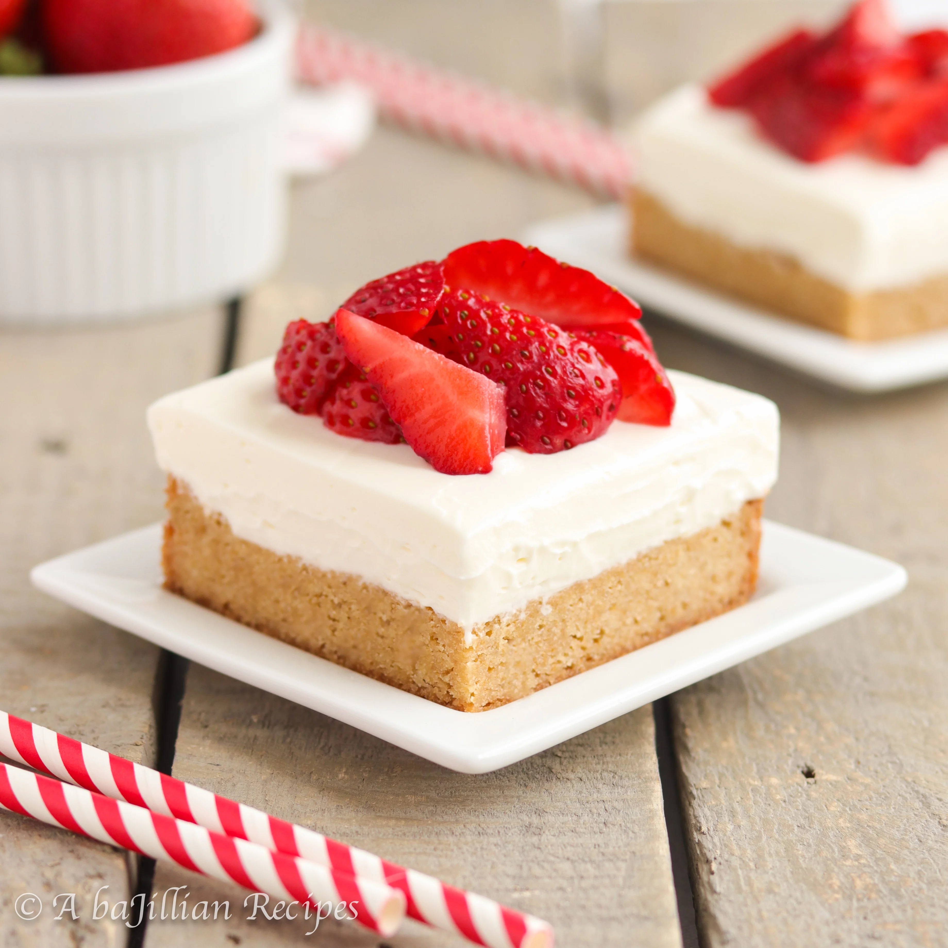 Deliciously thick and chewy blondies with a fluffy sweet cream topping and freshly sliced strawberries!