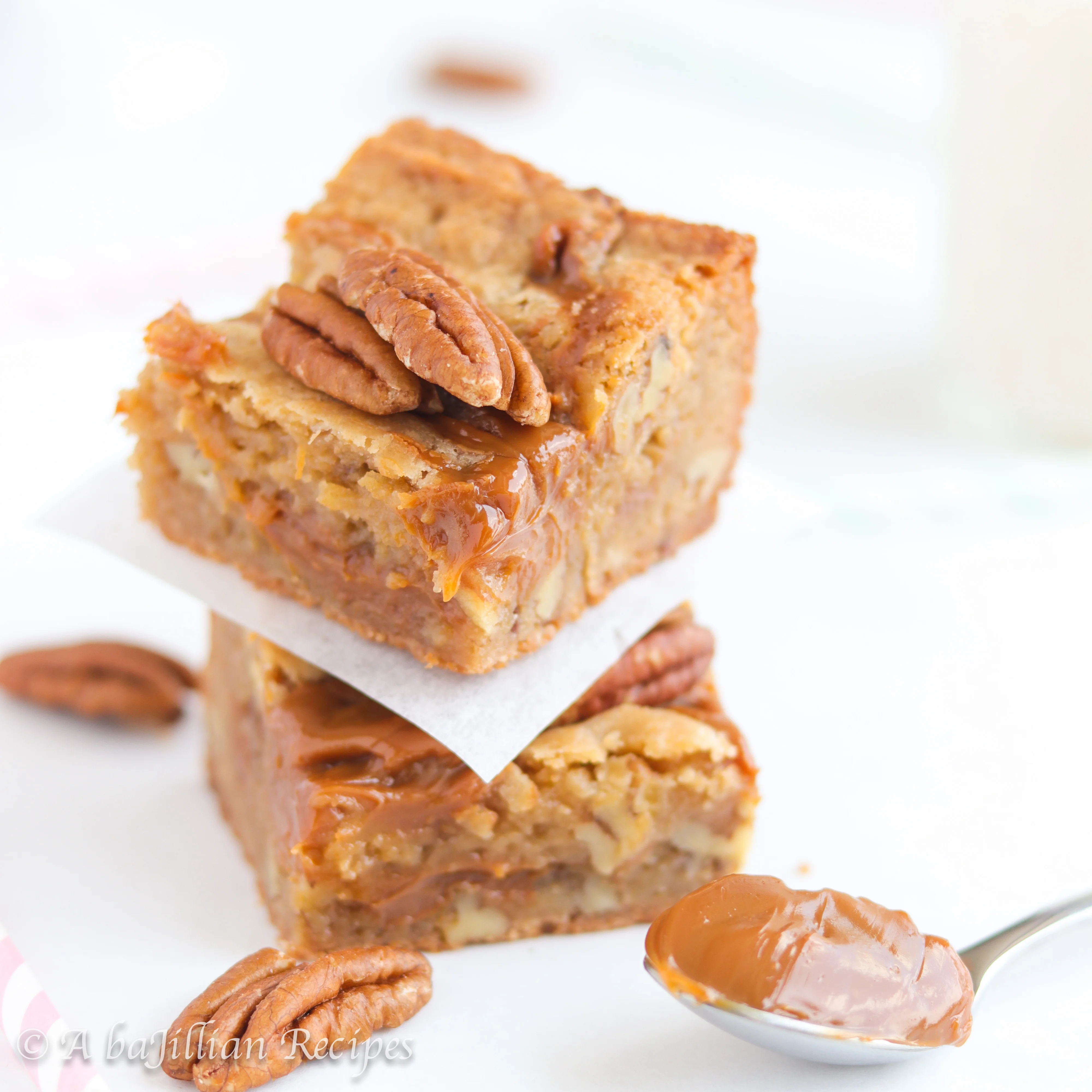 Thick and chewy brown butter blondies packed with pecans and ooey gooey pockets of dulce de leche!
