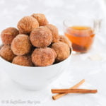 Soft and pillowy donut muffins infused with delicious apple cider and fall spices, coated in butter and cinnamon-sugar!