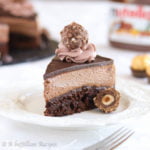 A rich and chewy brownie base topped with a layer of no-bake Nutella cheesecake, chocolate ganache, chocolate whipped cream rosettes, and Ferrero Rocher chocolates!