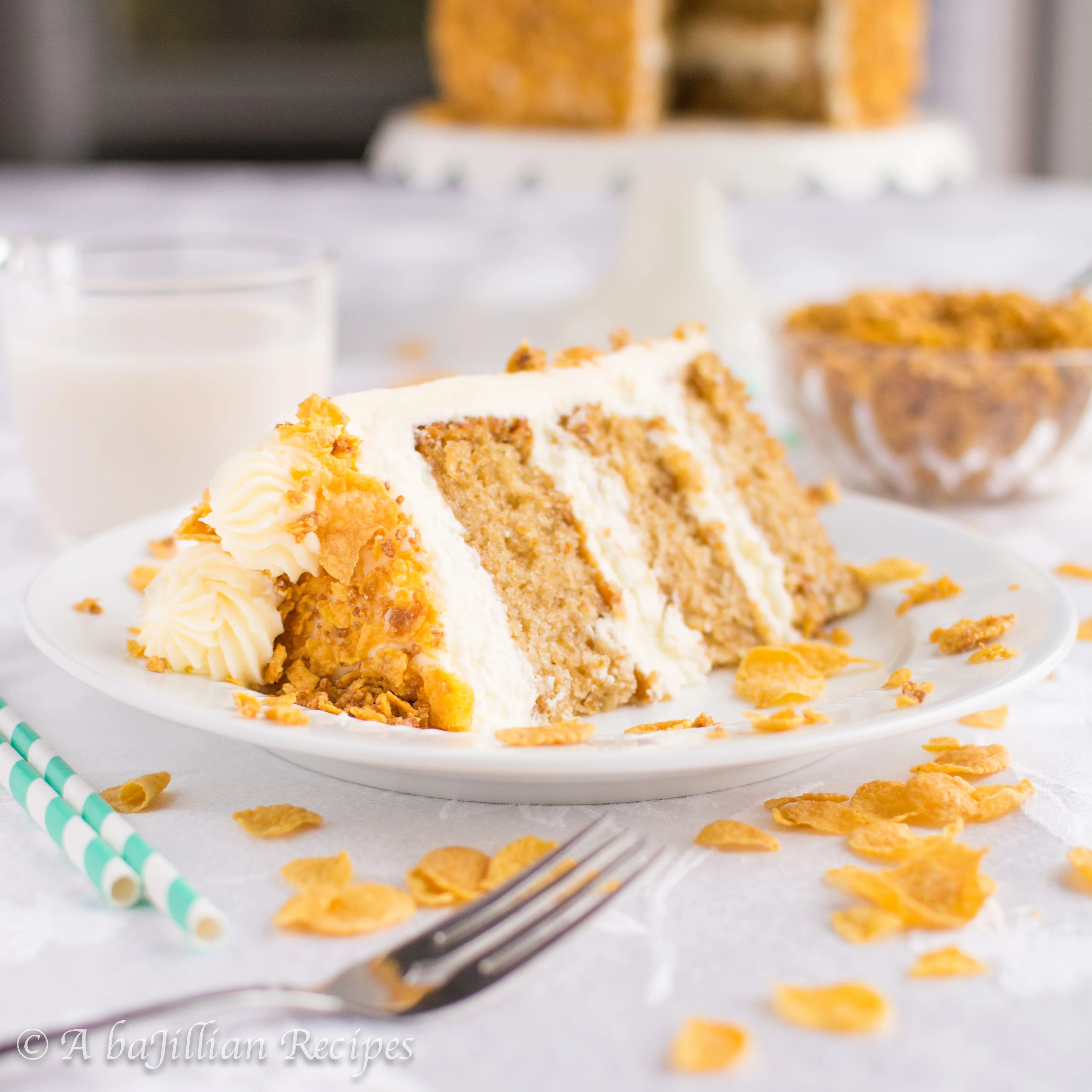 This Cereal Milk Cake is filled with fluffy cereal milk cheesecake mousse, frosted in rich cereal milk frosting, and coated in a sweetened cornflake crunch!
