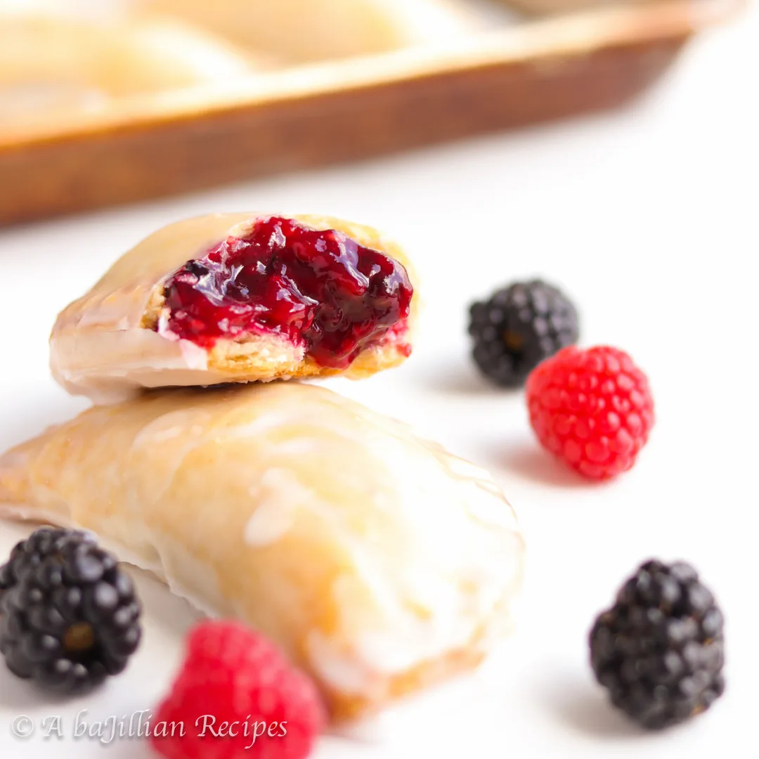 Homemade raspberry-blackberry filling tucked in a deliciously buttery, flakey crust and glazed in a gown of icing!