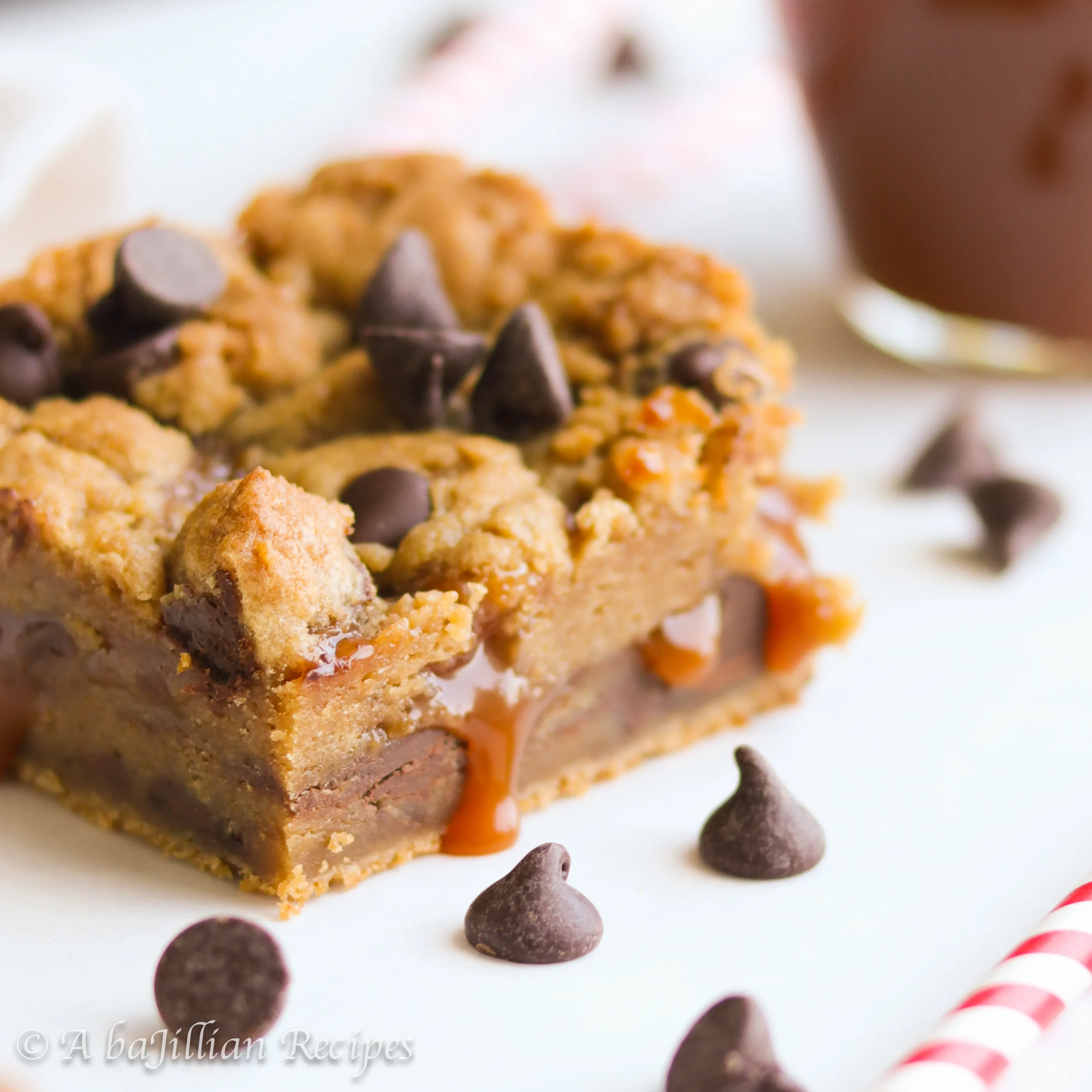Soft and doughy chocolate chip cookie bars infused with brown butter and filled with ooey gooey salted caramel!