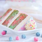 Moist layers of Cotton Candy Cap'n Crunch cake layered between a fluffy cheesecake mousse, and beautifully frosted in creamy vanilla buttercream!