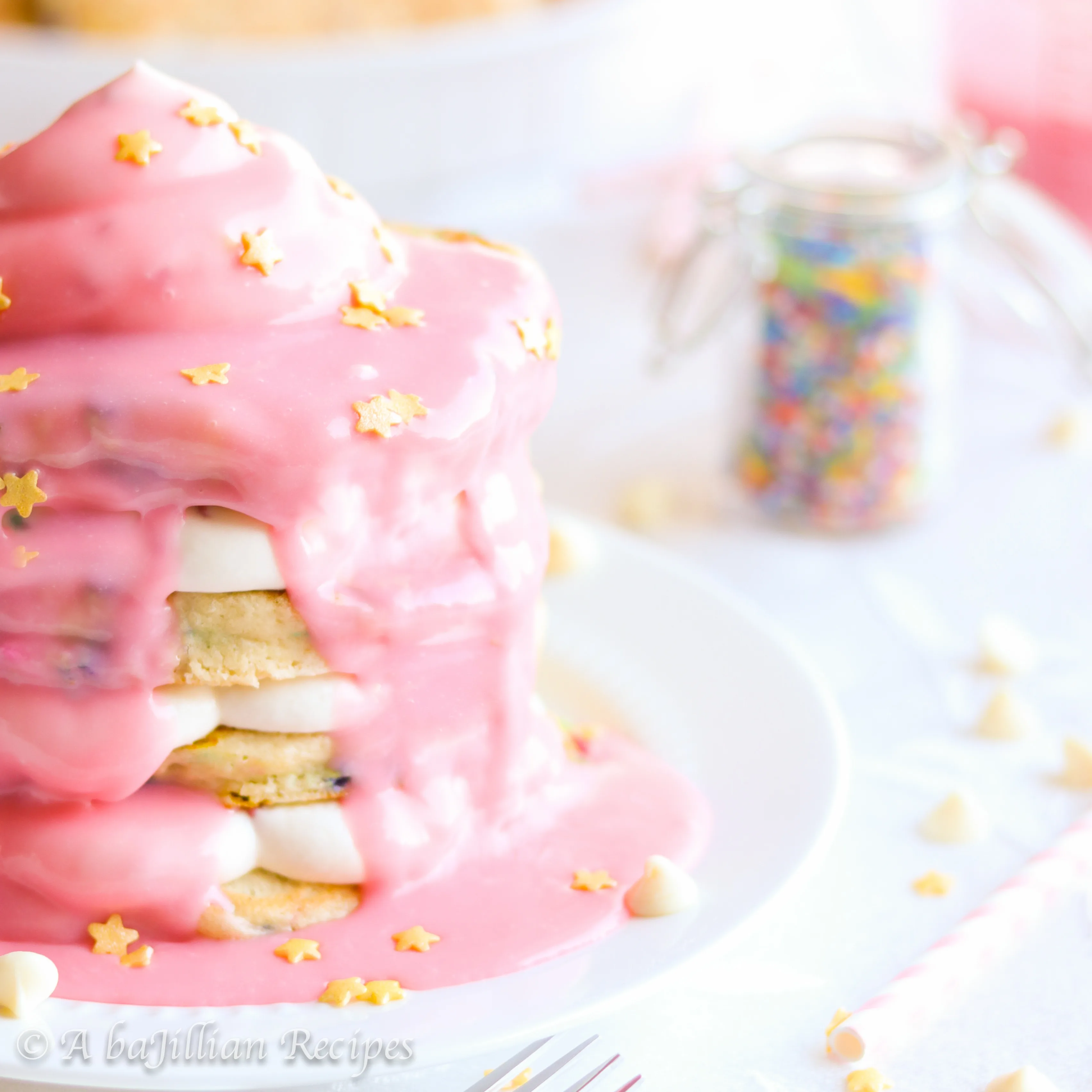 Fluffy flapjacks loaded with cake batter sweetness and sprinkles, layered with fluffy rainbow chip cheesecake mousse, and enrobed in rich white chocolate ganache!