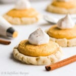 Soft and chewy sugar cookies topped with the most heavenly pumpkin buttercream frosting!