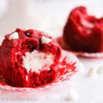 Moist and fluffy red velvet muffins loaded with white chocolate chips and filled with a sweetened cream cheese center!