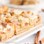 Layers upon layers of deliciousness in these ooey gooey Snickerdoodle Magic Bars! The bars are layered with a snickerdoodle cookie crust, Brown Sugar Cinnamon Pop-Tarts, marshmallows, cinnamon chips, white chocolate chips, and sweetened condensed milk. Cinnamon sugar heaven!