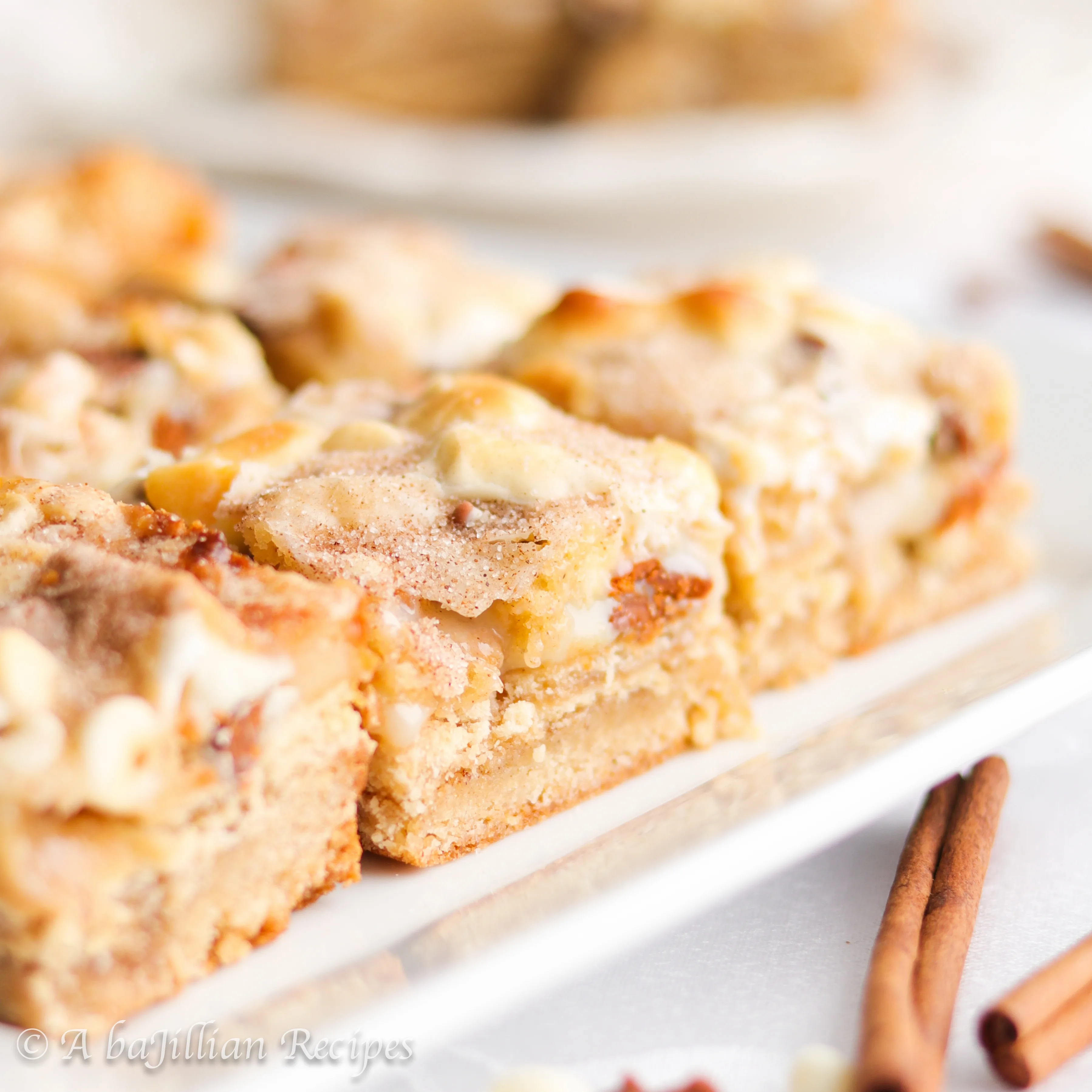 Layers upon layers of deliciousness in these ooey gooey Snickerdoodle Magic Bars! The bars are layered with a snickerdoodle cookie crust, Brown Sugar Cinnamon Pop-Tarts, marshmallows, cinnamon chips, white chocolate chips, and sweetened condensed milk. Cinnamon sugar heaven!