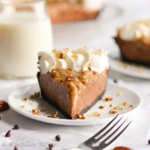 This easy no-bake pie features a chocolate cookie crust, rich chocolate filling, and gooey toasted coconut-pecan topping!