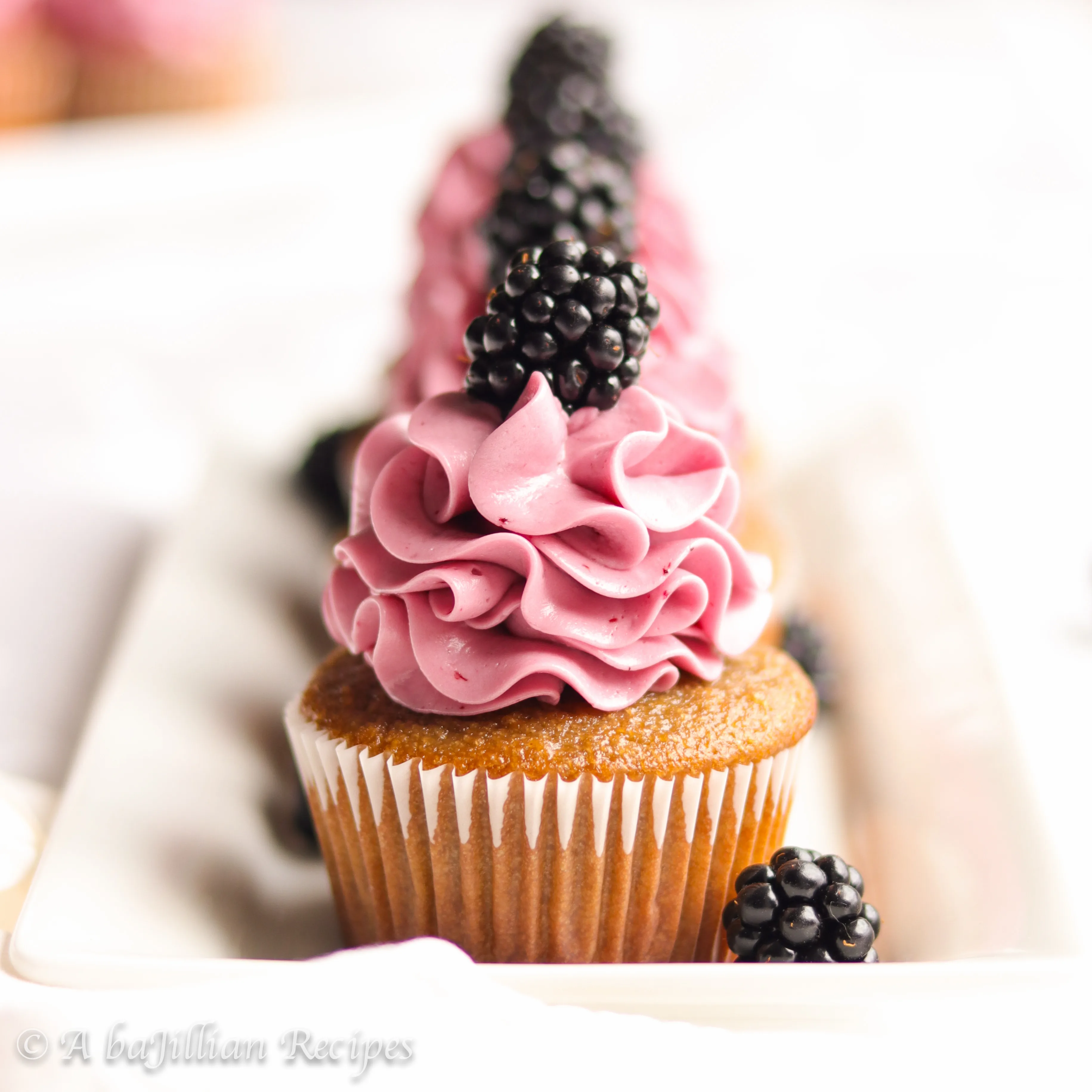 Perfectly moist and fluffy blackberry cupcakes topped with the silkiest melt-in-your-mouth blackberry Swiss meringue buttercream!