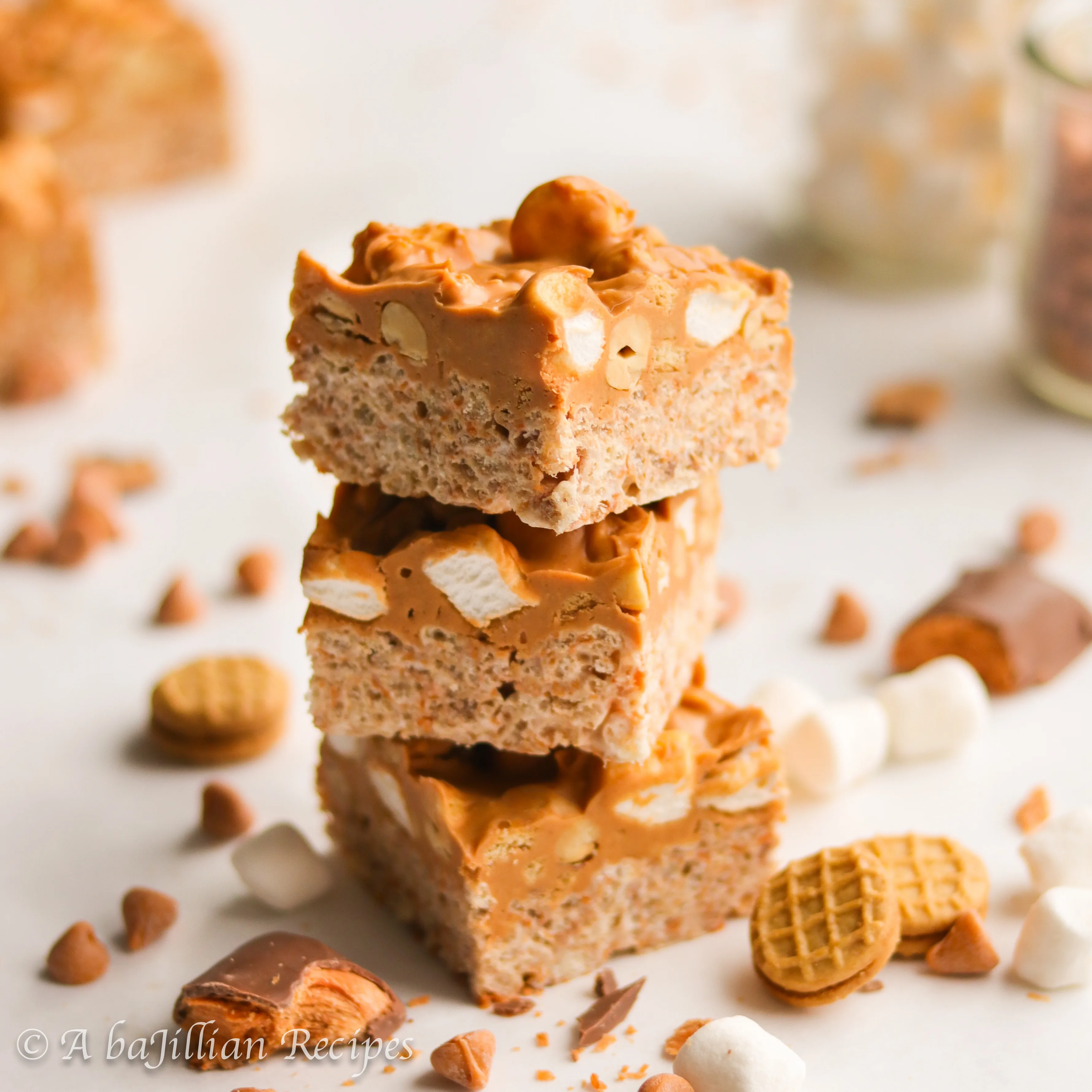 Ooey gooey Butterfinger rice krispies treats topped with a peanut buttery butterscotch layer loaded with peanuts, marshmallows, and Nutter Butter cookies!