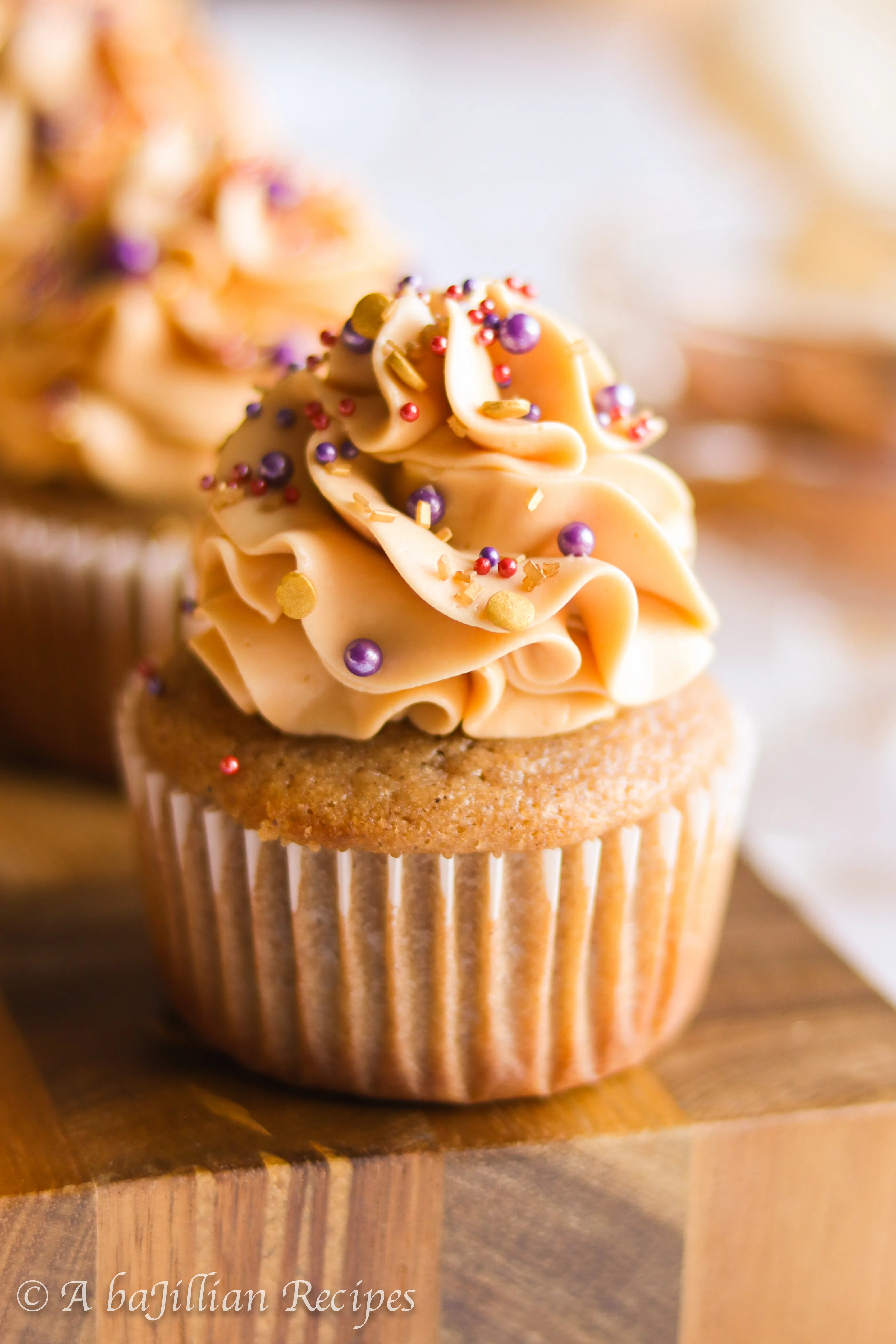 Deliciously moist and fluffy pear cupcakes filled with rich dulce de leche and topped with a silky crown of dulce de leche swiss meringue buttercream!