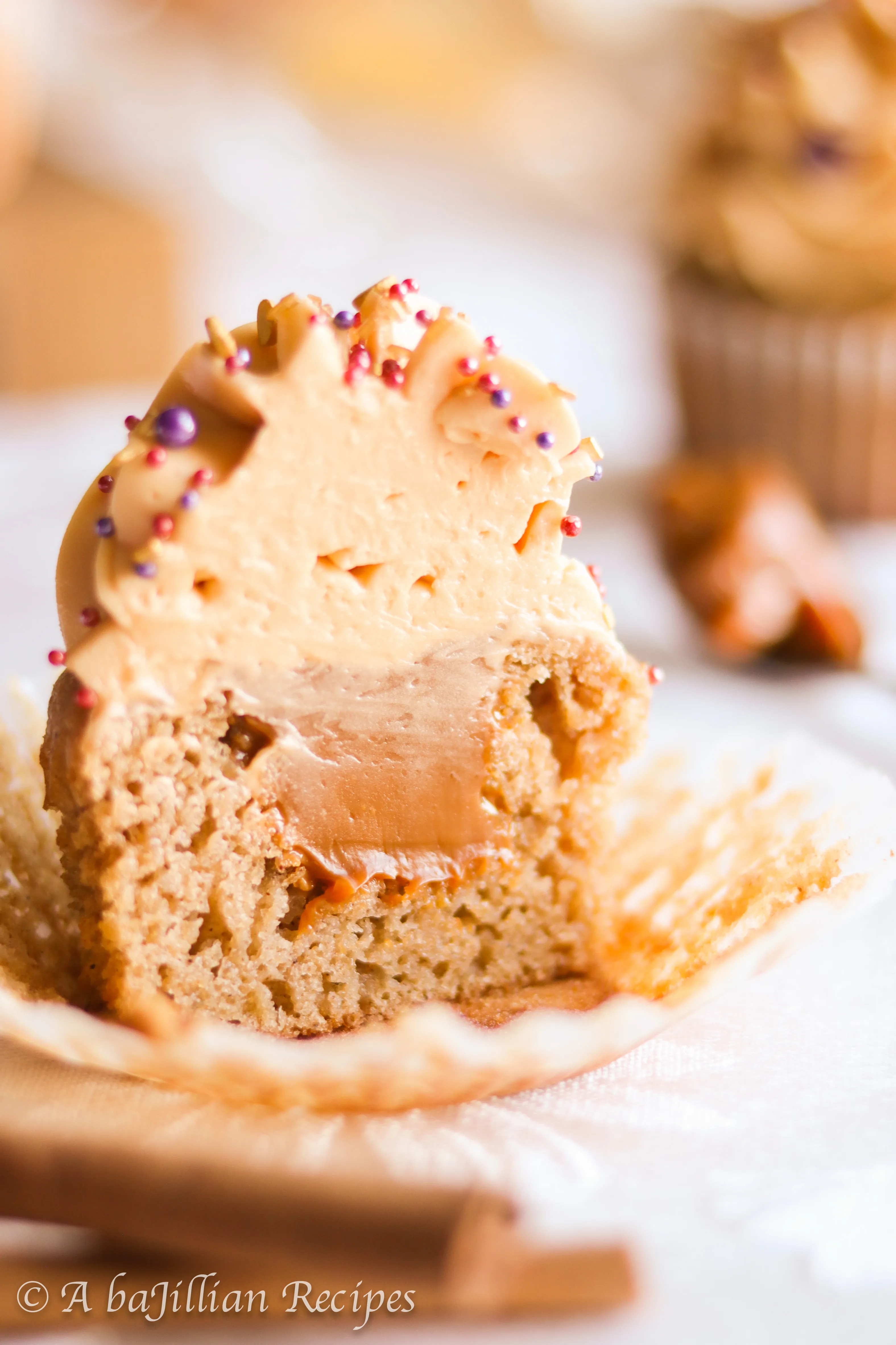 Deliciously moist and fluffy pear cupcakes filled with rich dulce de leche and topped with a silky crown of dulce de leche swiss meringue buttercream!