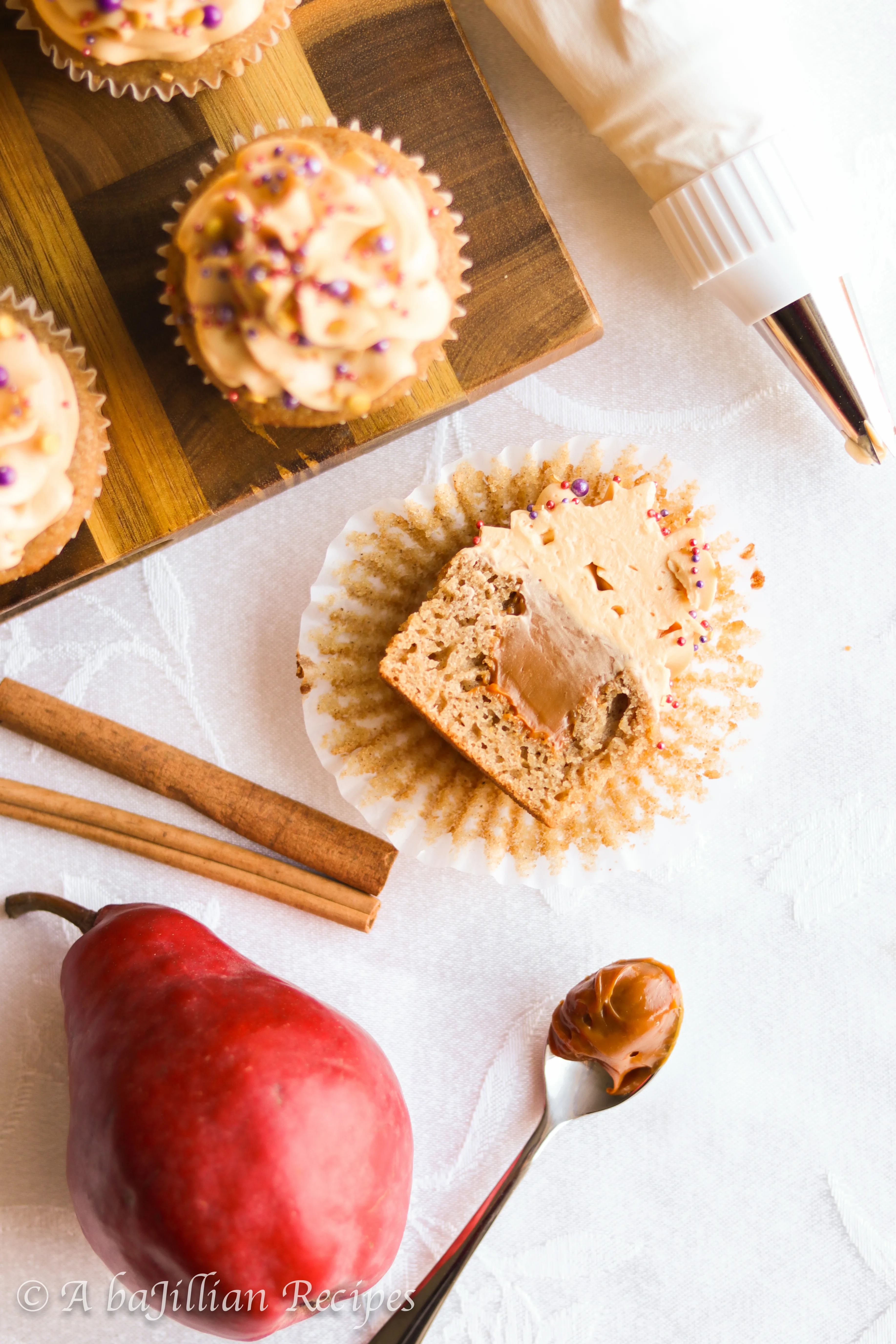 Deliciously moist and fluffy pear cupcakes filled with rich dulce de leche and topped with a silky crown of dulce de leche swiss meringue buttercream!
