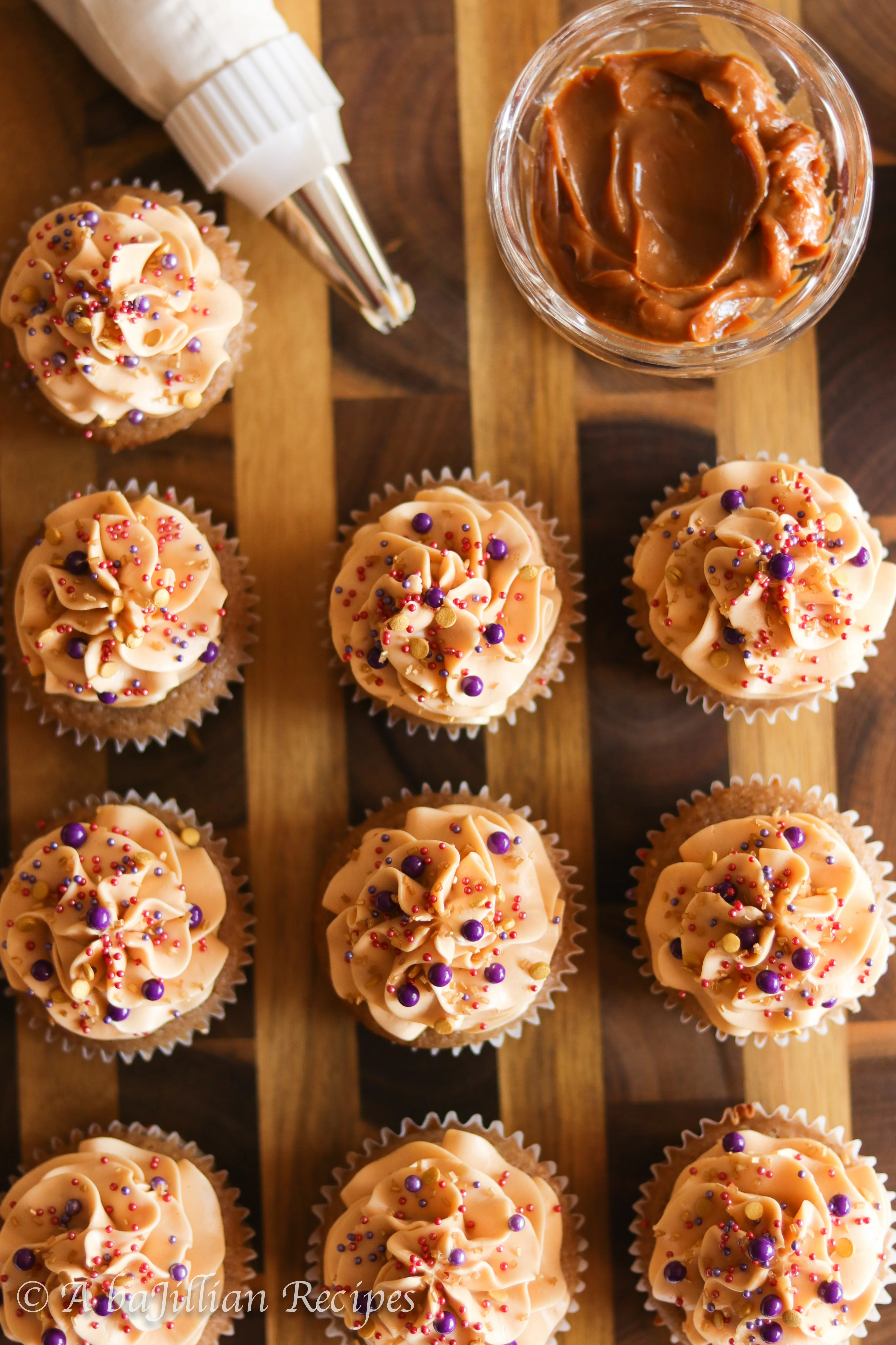Deliciously moist and fluffy pear cupcakes filled with rich dulce de leche and topped with a silky crown of dulce de leche swiss meringue buttercream!
