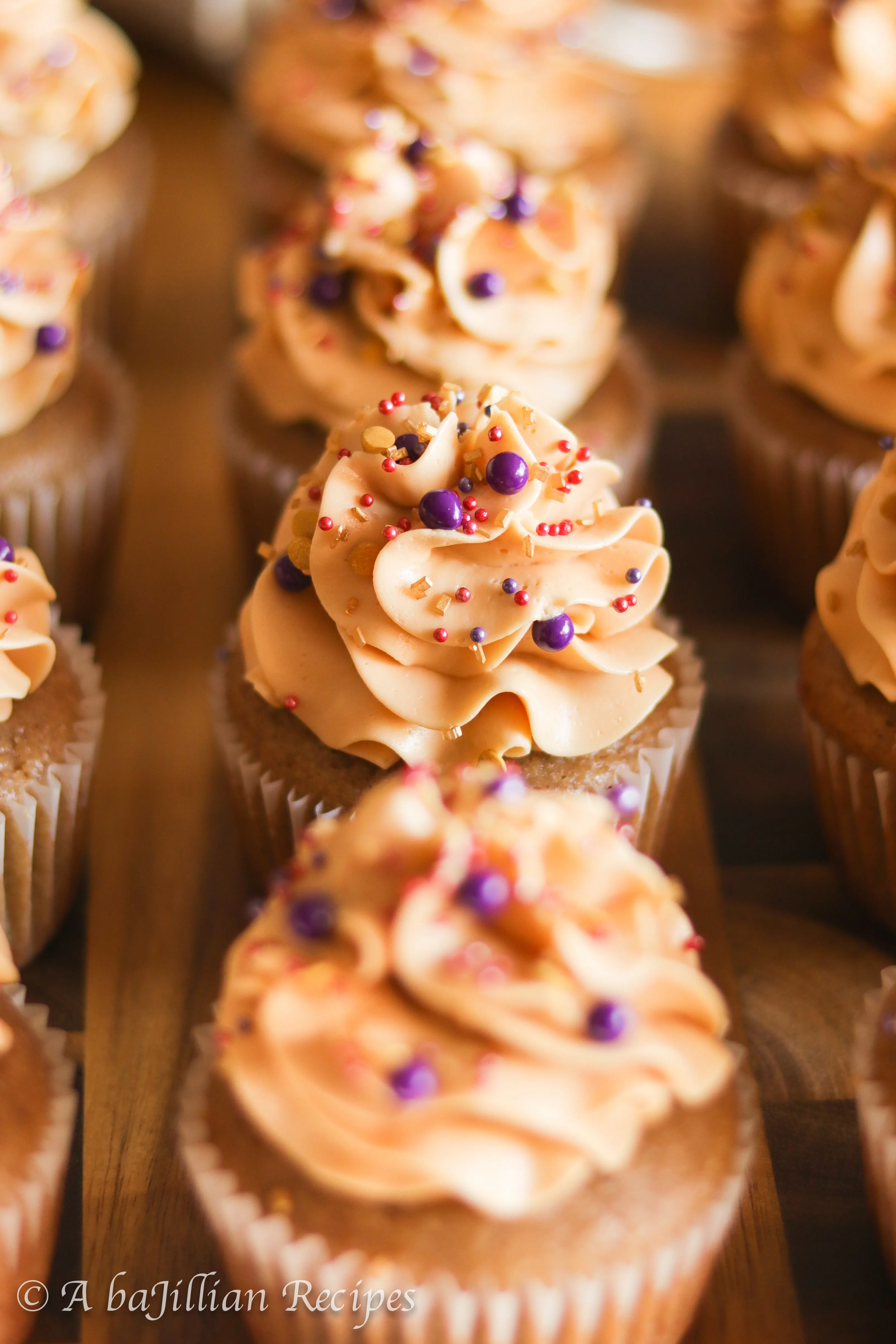 Deliciously moist and fluffy pear cupcakes filled with rich dulce de leche and topped with a silky crown of dulce de leche swiss meringue buttercream!