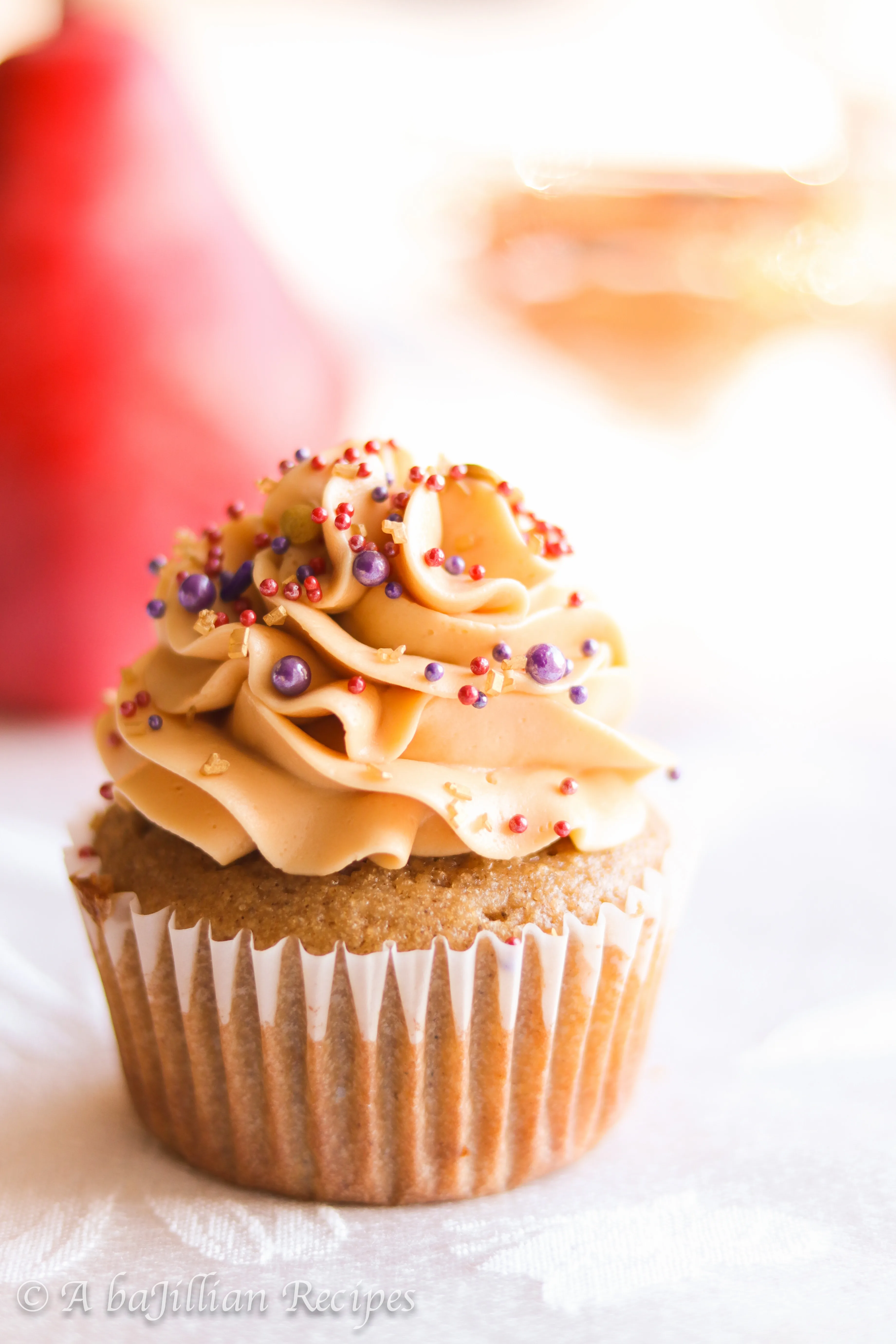 Deliciously moist and fluffy pear cupcakes filled with rich dulce de leche and topped with a silky crown of dulce de leche swiss meringue buttercream!