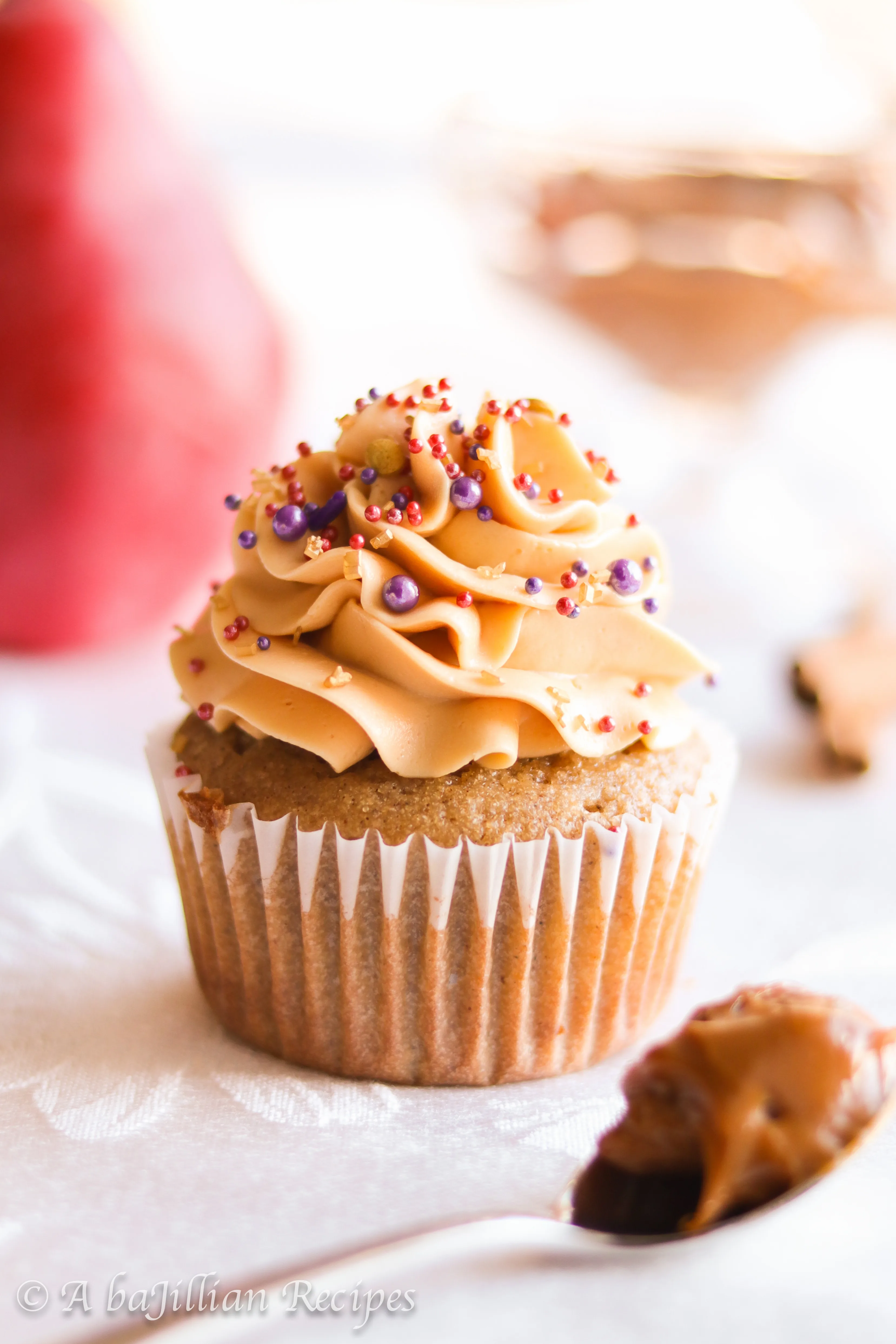 Deliciously moist and fluffy pear cupcakes filled with rich dulce de leche and topped with a silky crown of dulce de leche swiss meringue buttercream!