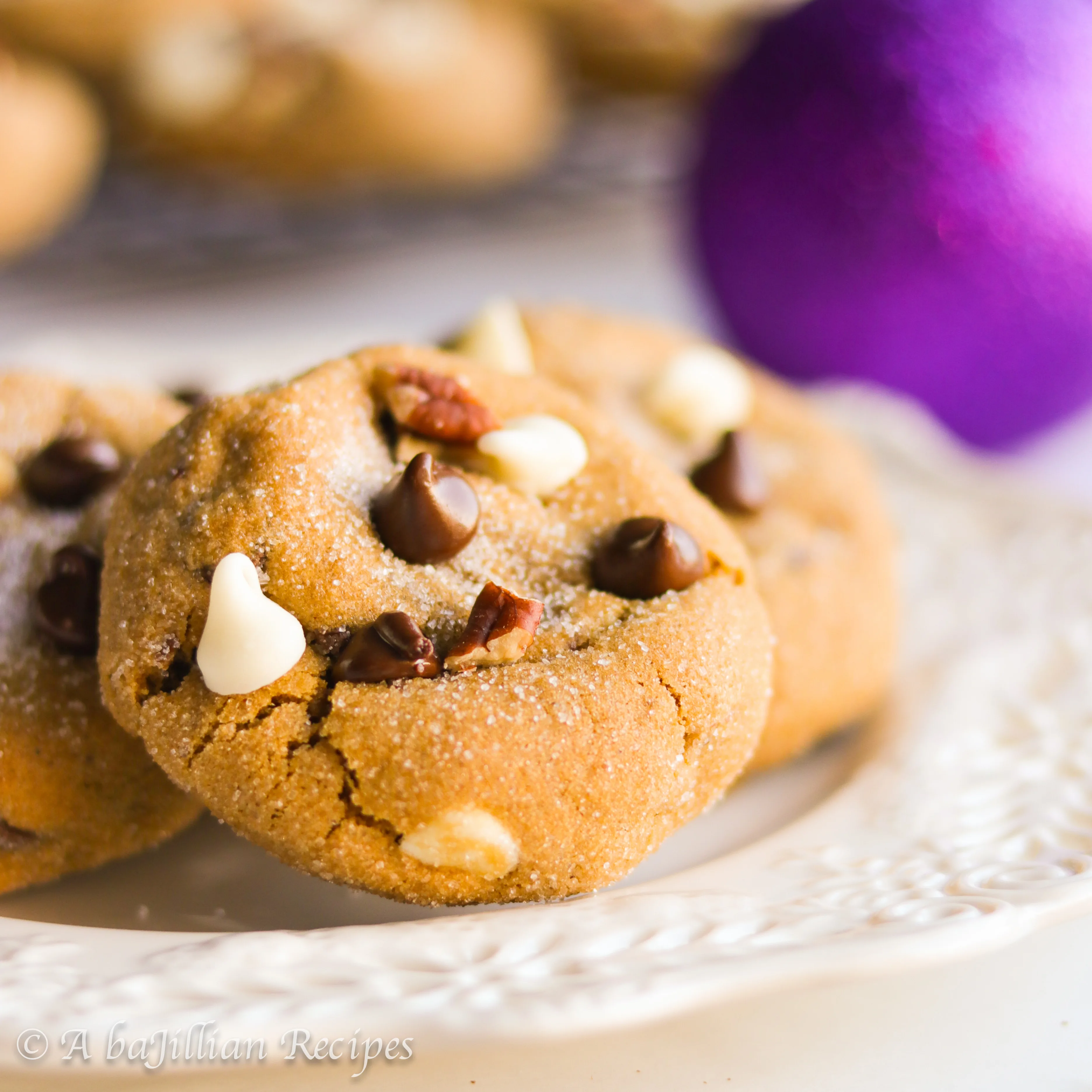 Soft and chewy sugar-coated gingerbread cookies brimming with dark chocolate chips, white chocolate chips, and crunchy toasted pecans!